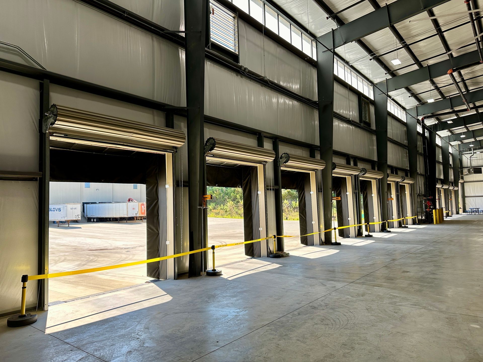 A large warehouse with a lot of doors open