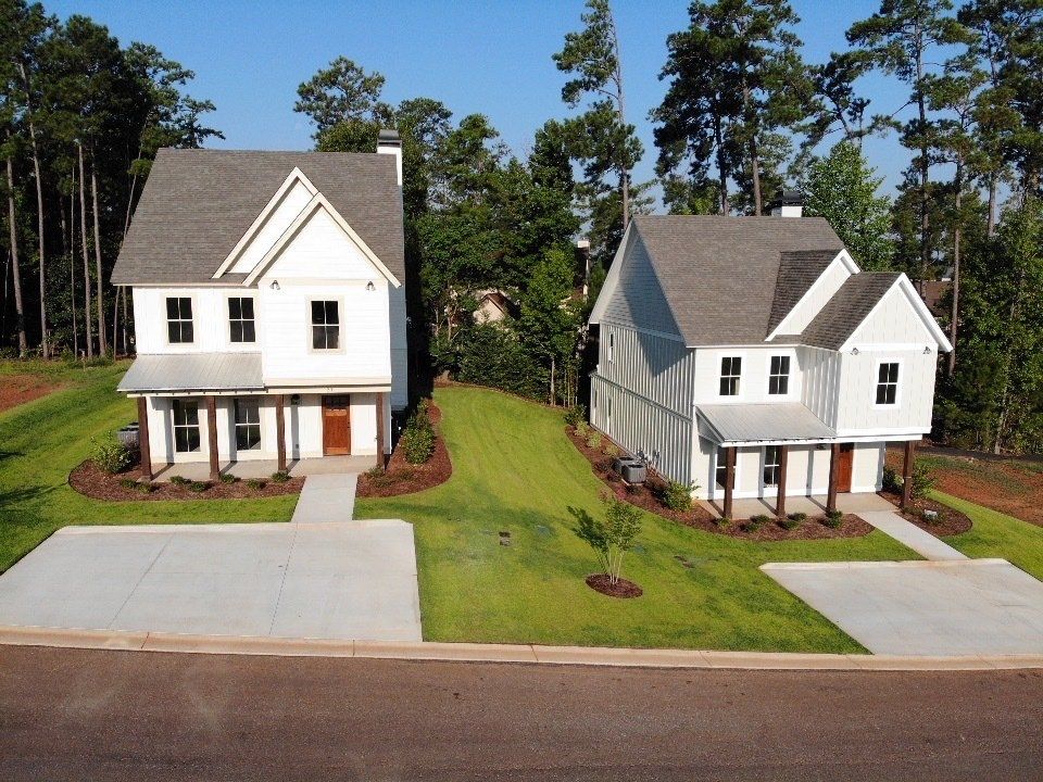 A couple of white houses sitting next to each other