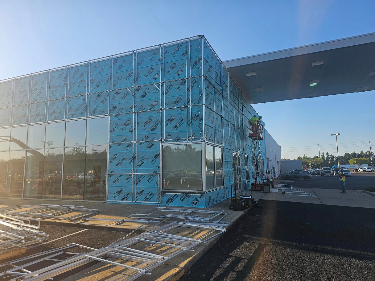 A large building with a lot of windows is being built.