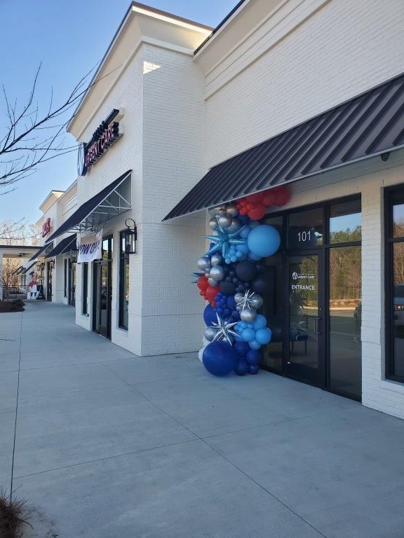 A store front with balloons in front of it