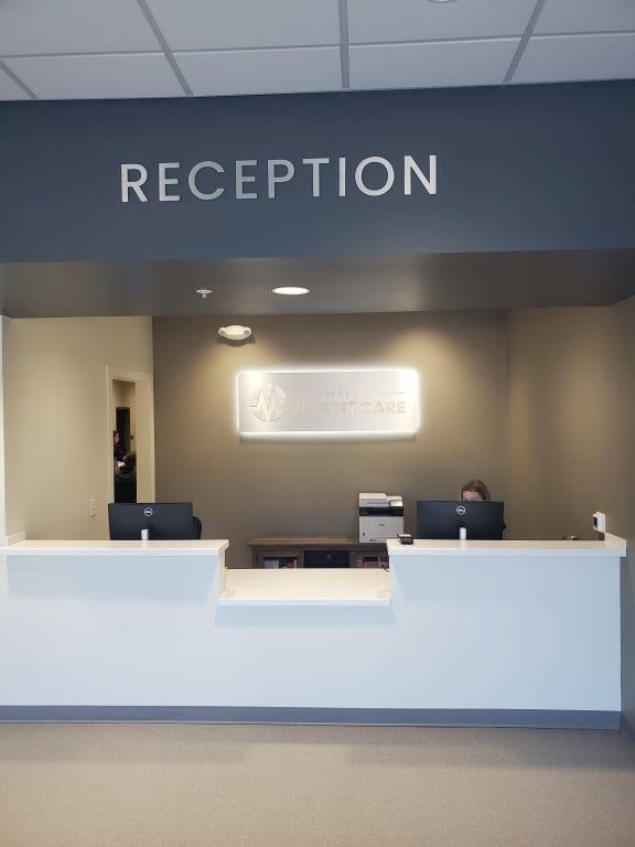 A reception desk with a sign above it that says reception