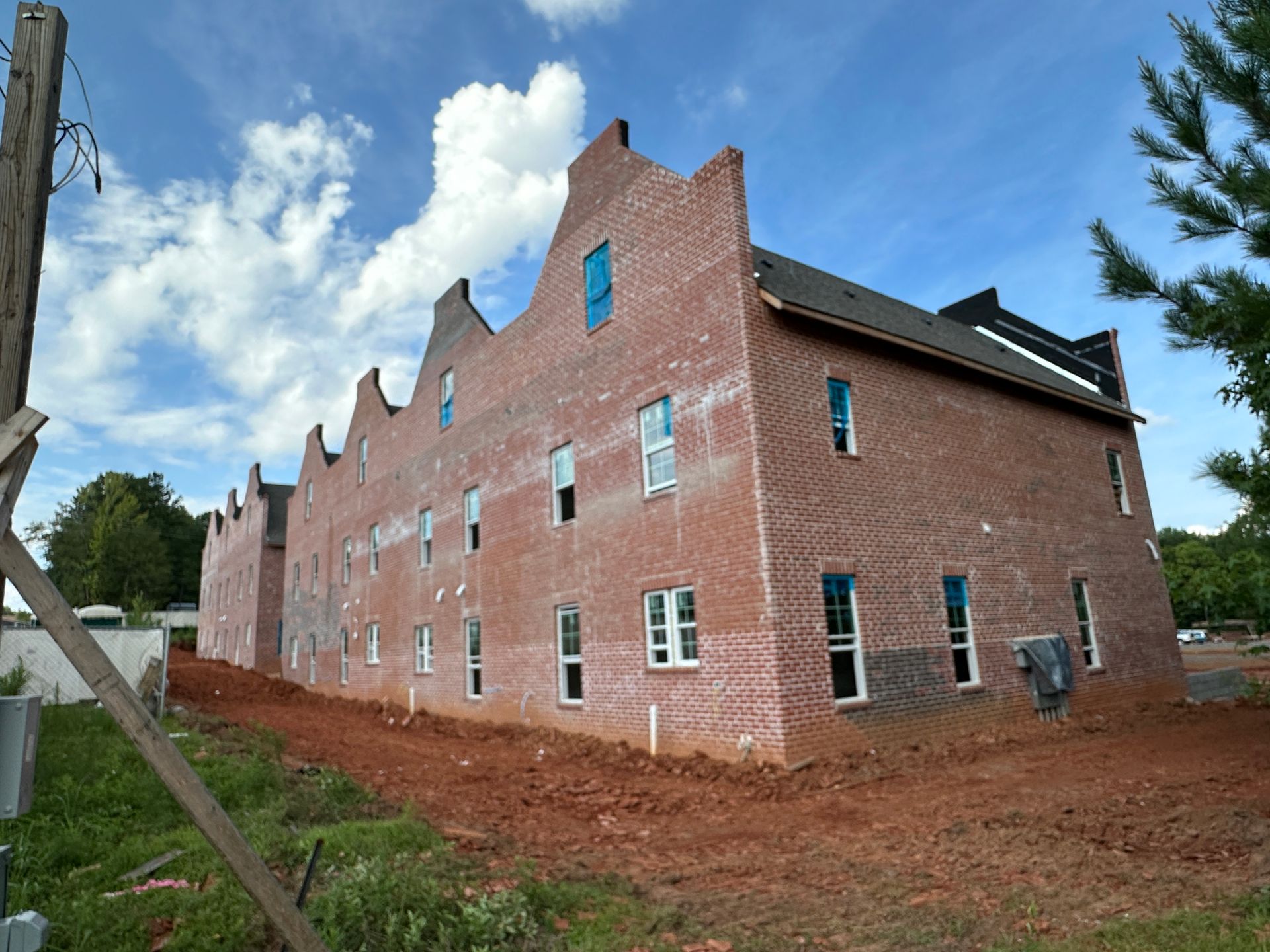A large brick building under construction with a lot of windows