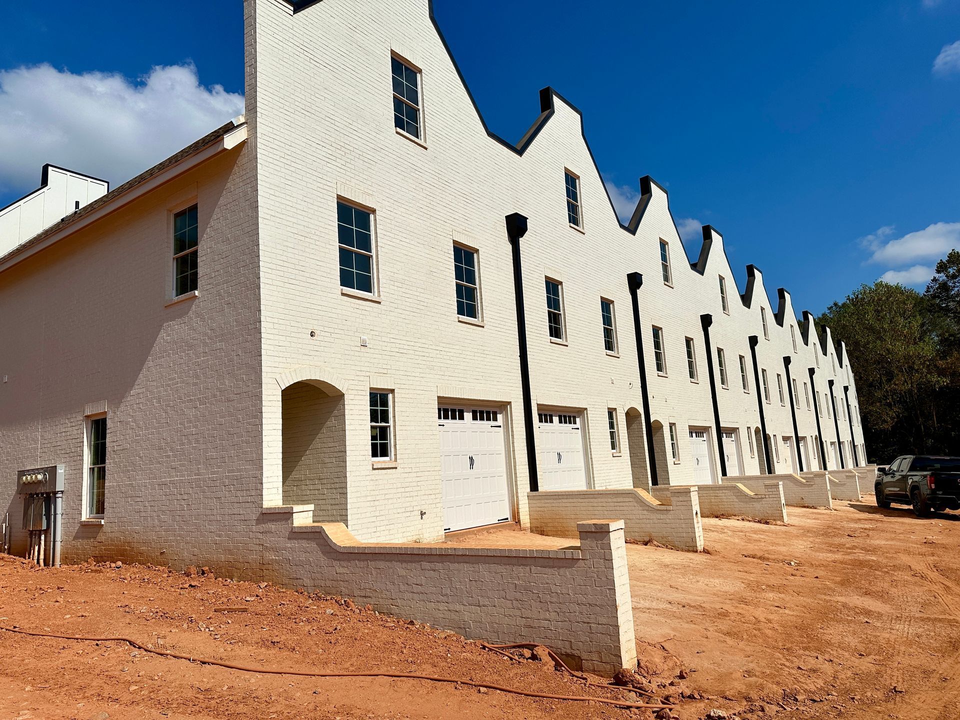 A large brick building under construction with a fence around it.