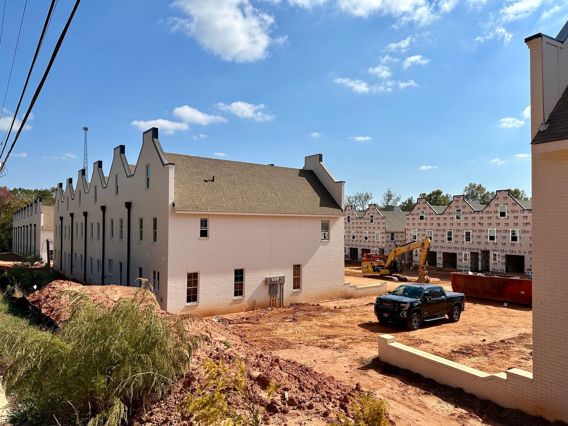 A truck is parked in front of a building under construction.