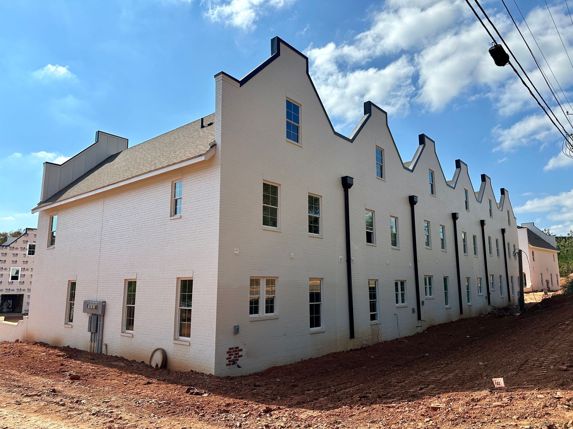 A large white building with a blue sky in the background