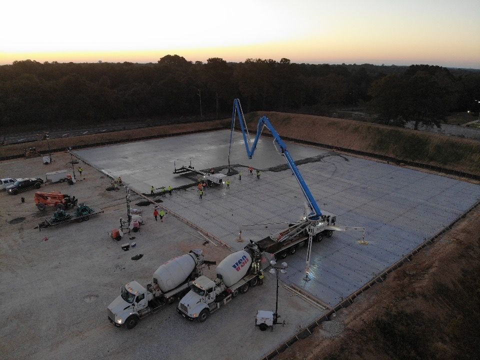 An aerial view of a construction site with trucks and a crane