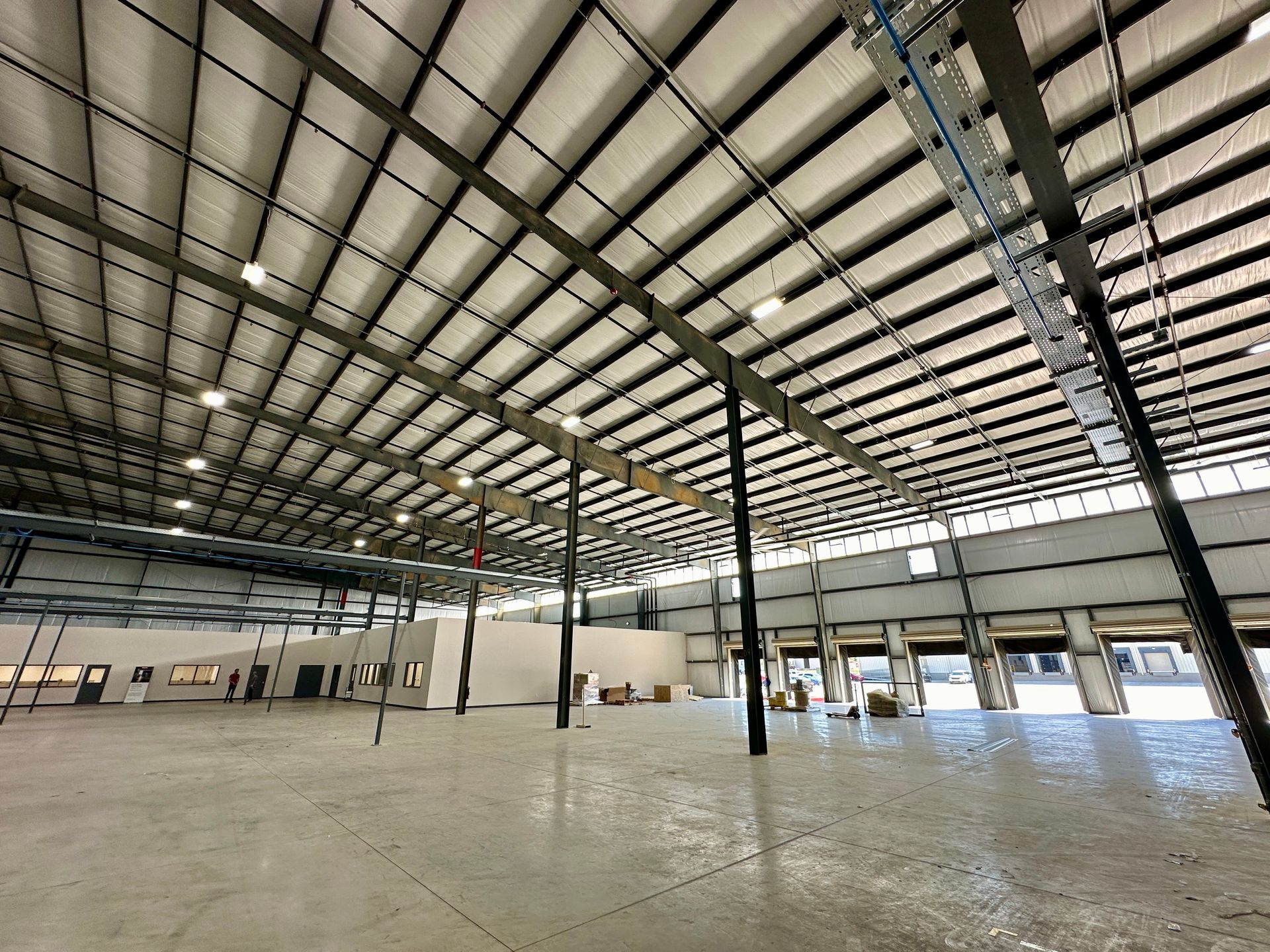 A large empty warehouse with a metal roof