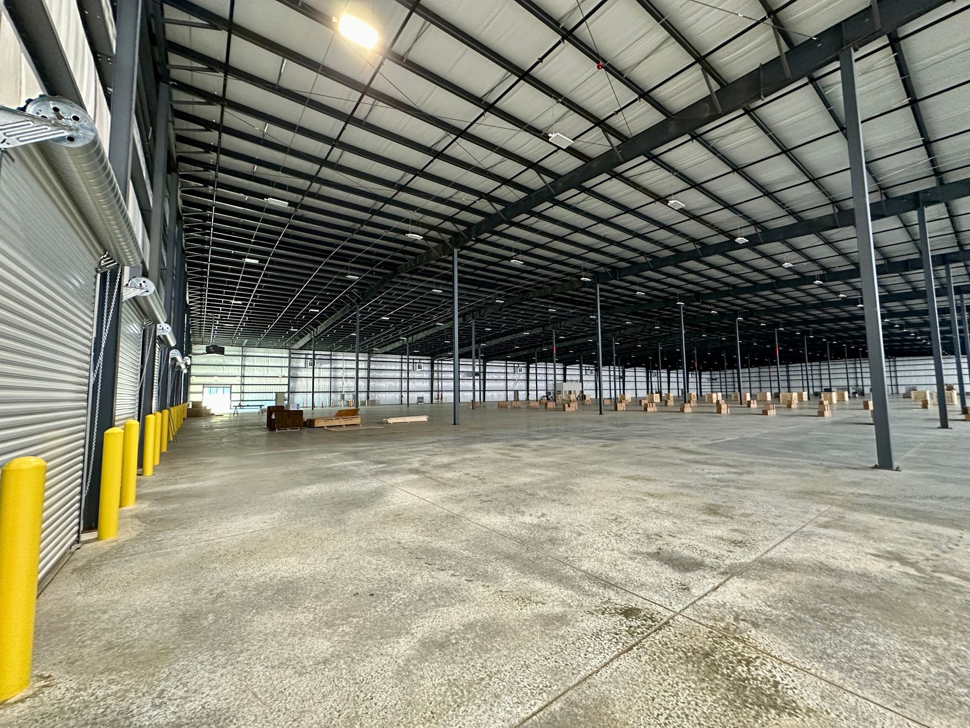 The inside of a large warehouse with a lot of empty space.
