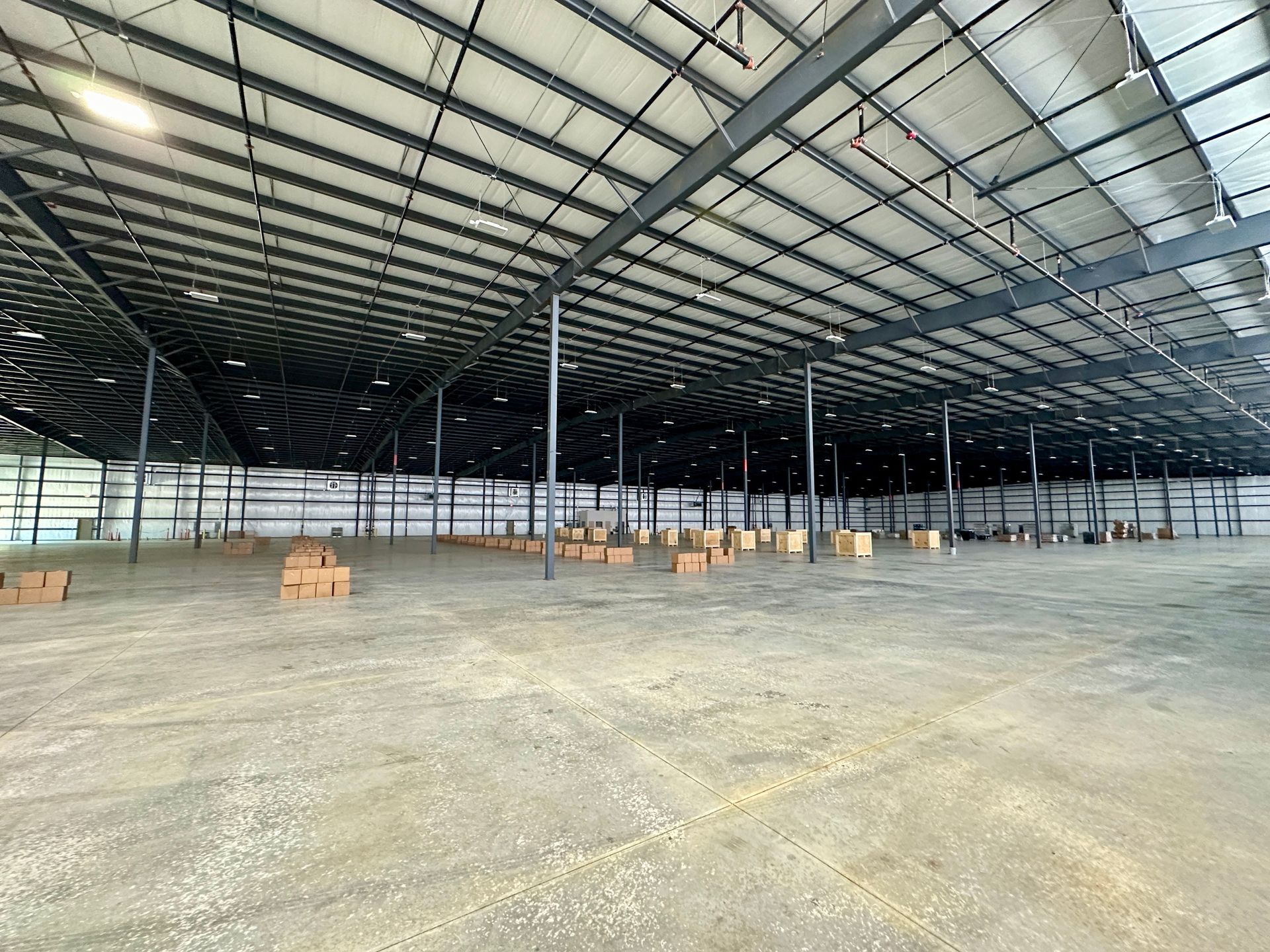 A large warehouse with a lot of boxes in it