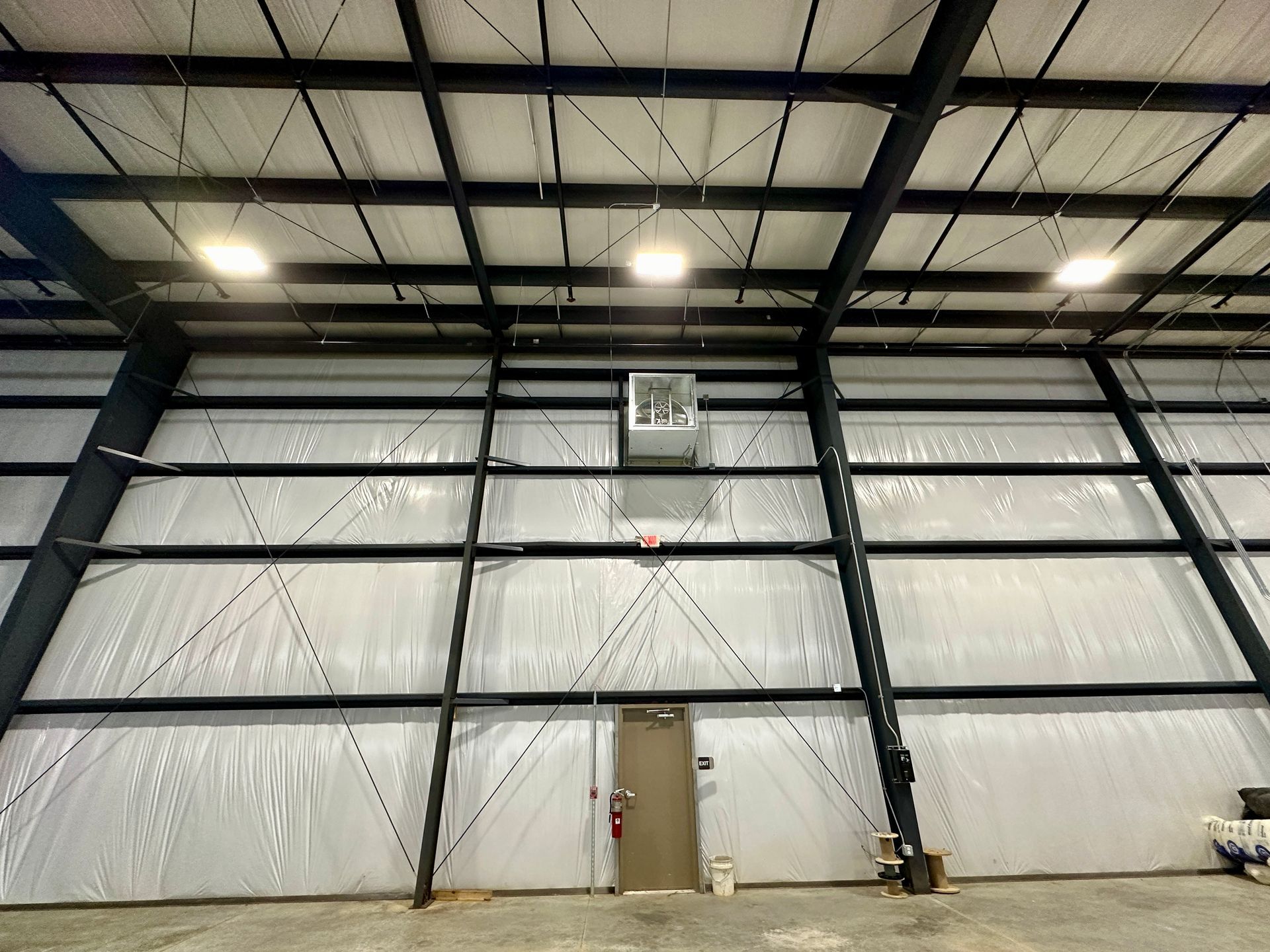 A large warehouse with a basketball hoop in the middle of it.