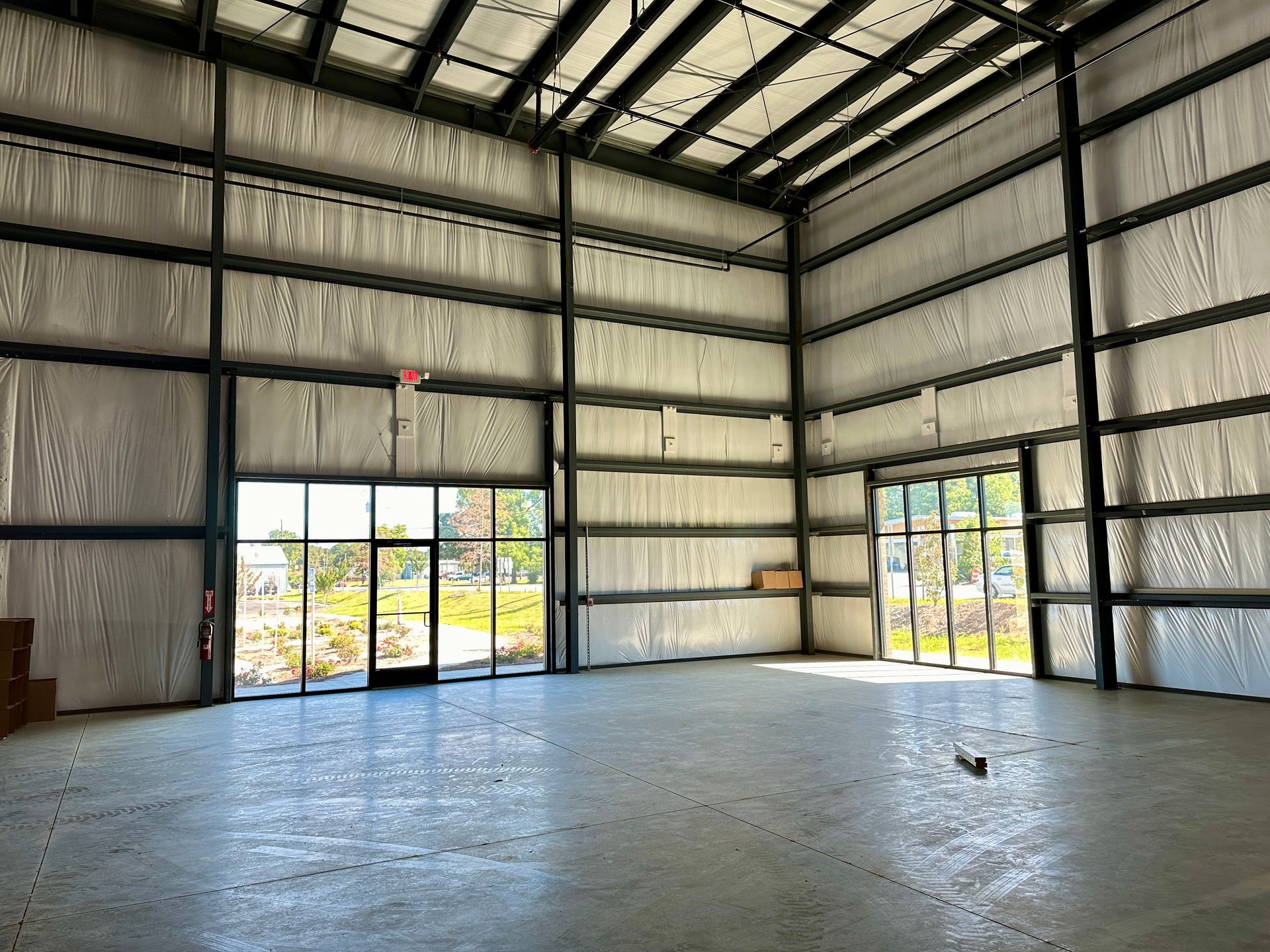 A large empty warehouse with a lot of windows.