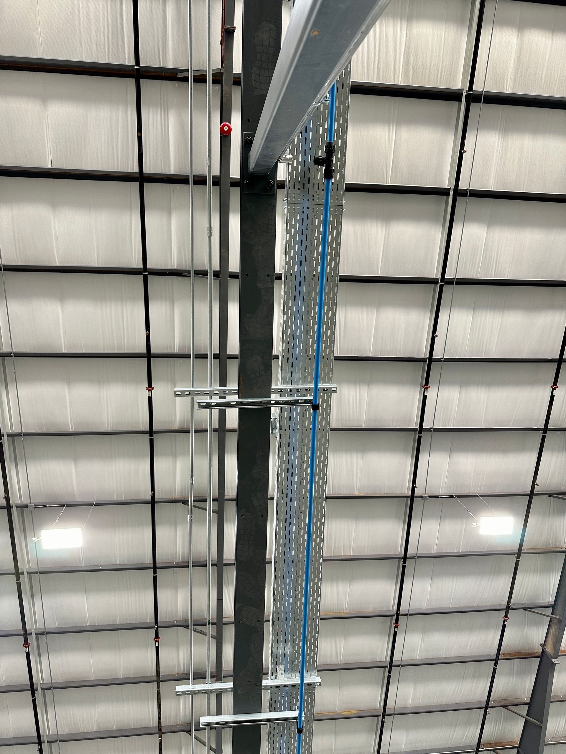 A pipe is hanging from the ceiling of a building