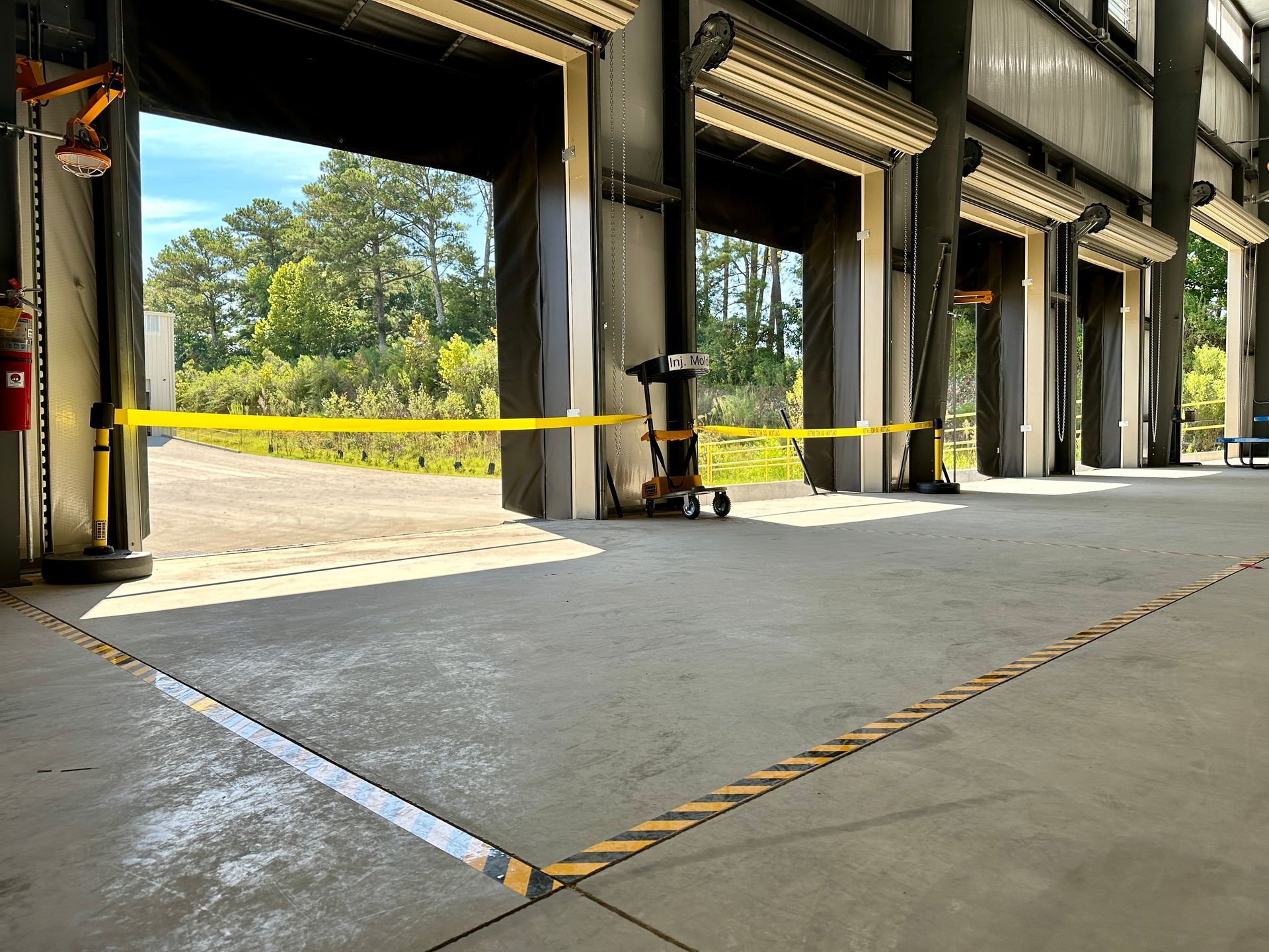 A warehouse with a lot of doors that are open