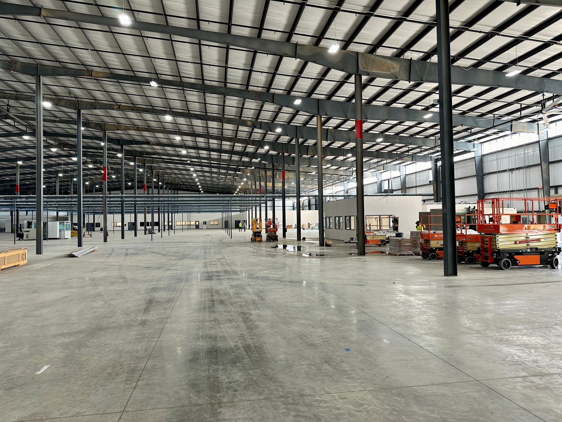 A large empty warehouse with a lot of machinery in it.