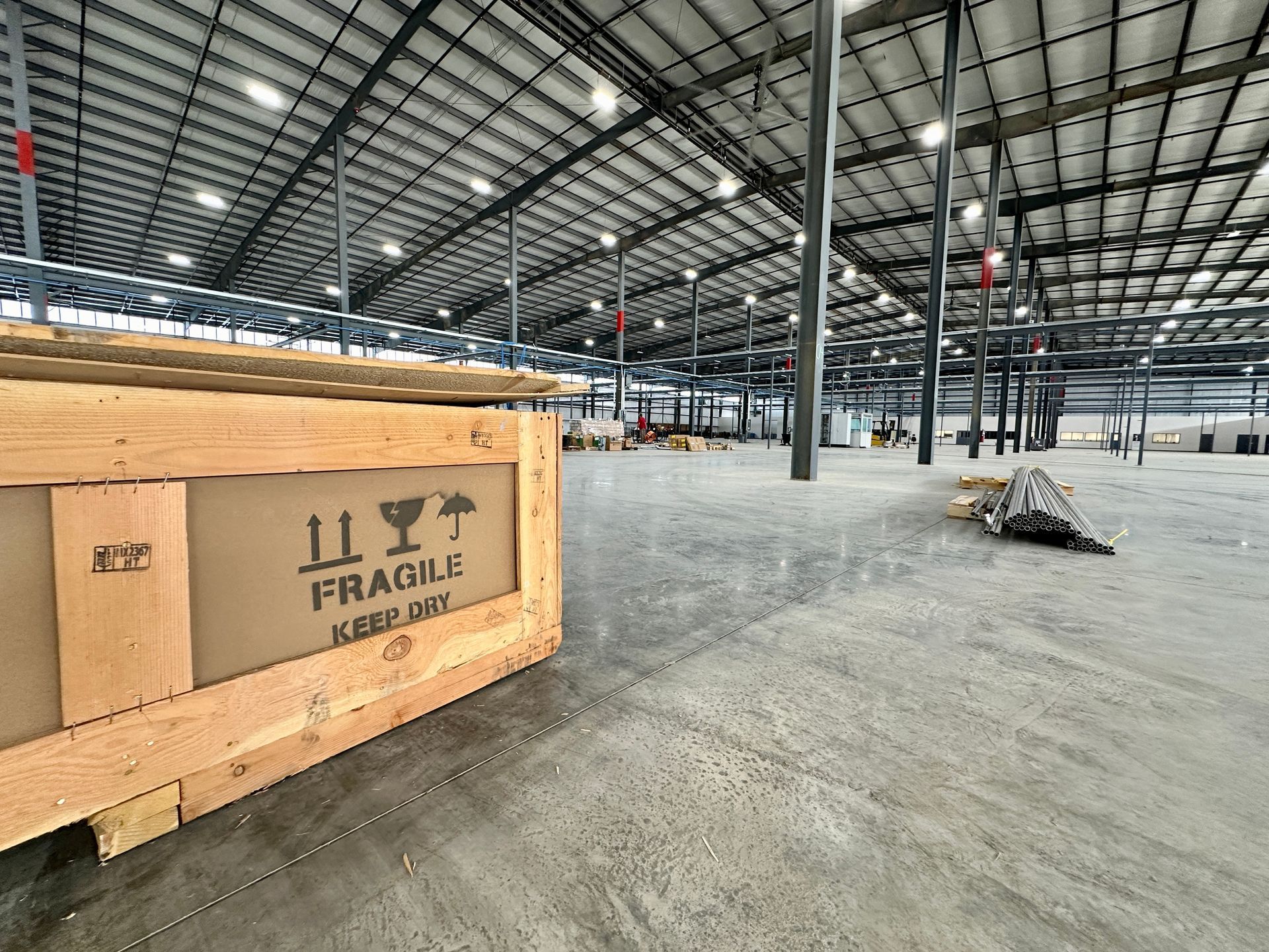 A large warehouse with a wooden box that says fragile on it.