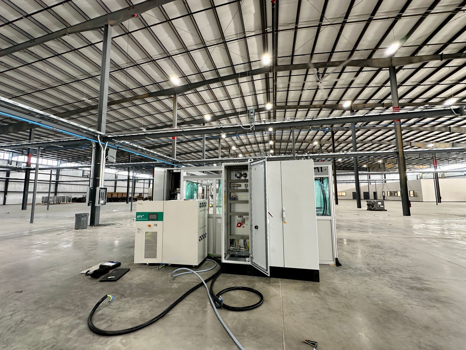 An empty warehouse with a machine in the middle of it