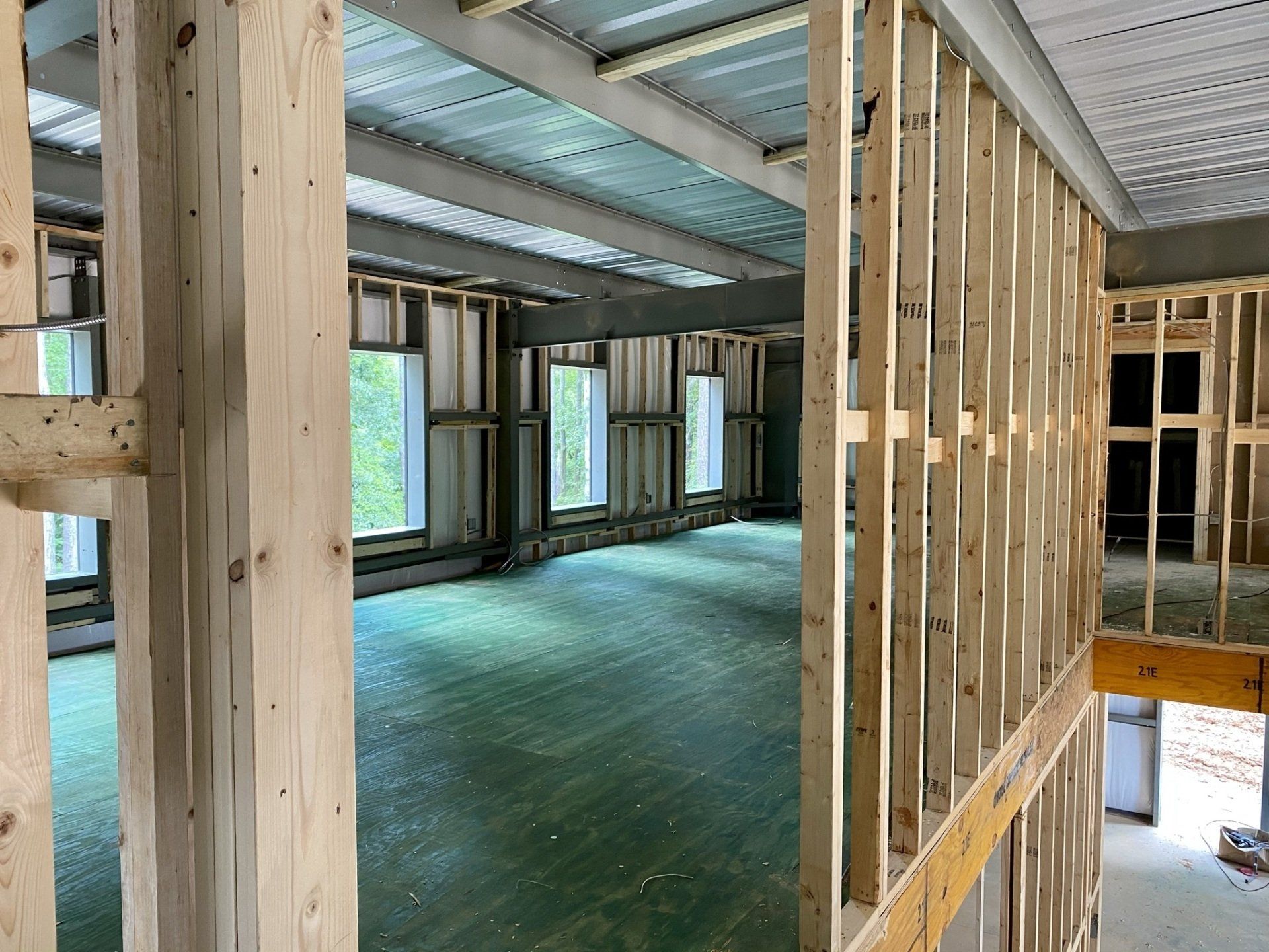 A building under construction with wooden beams and a ceiling.