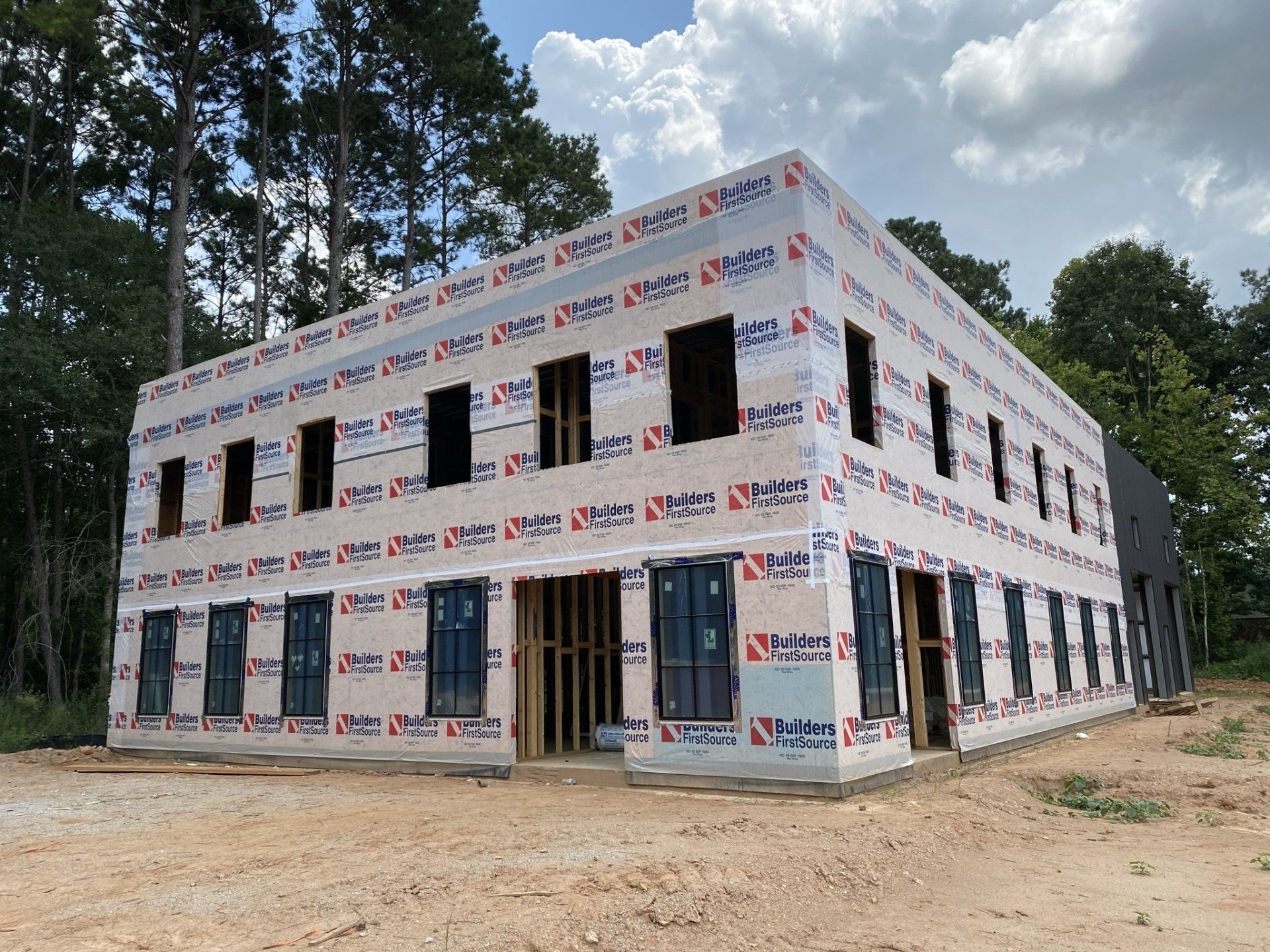 A large building is being built in the middle of a forest.