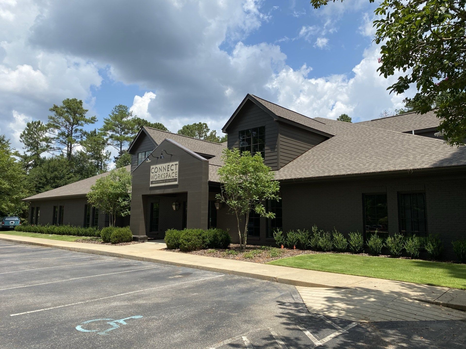 A large building with a parking lot in front of it