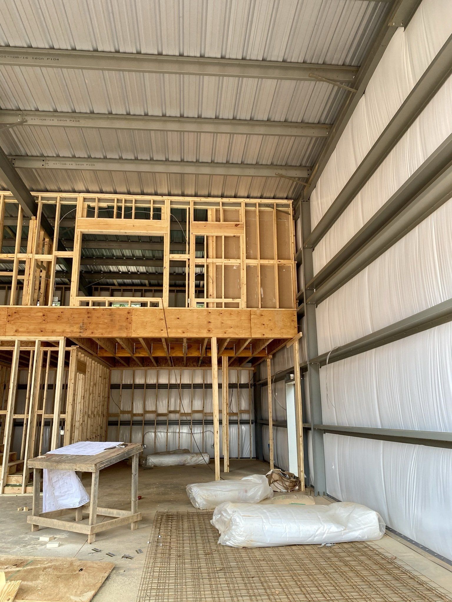 The inside of a building under construction with a second floor.