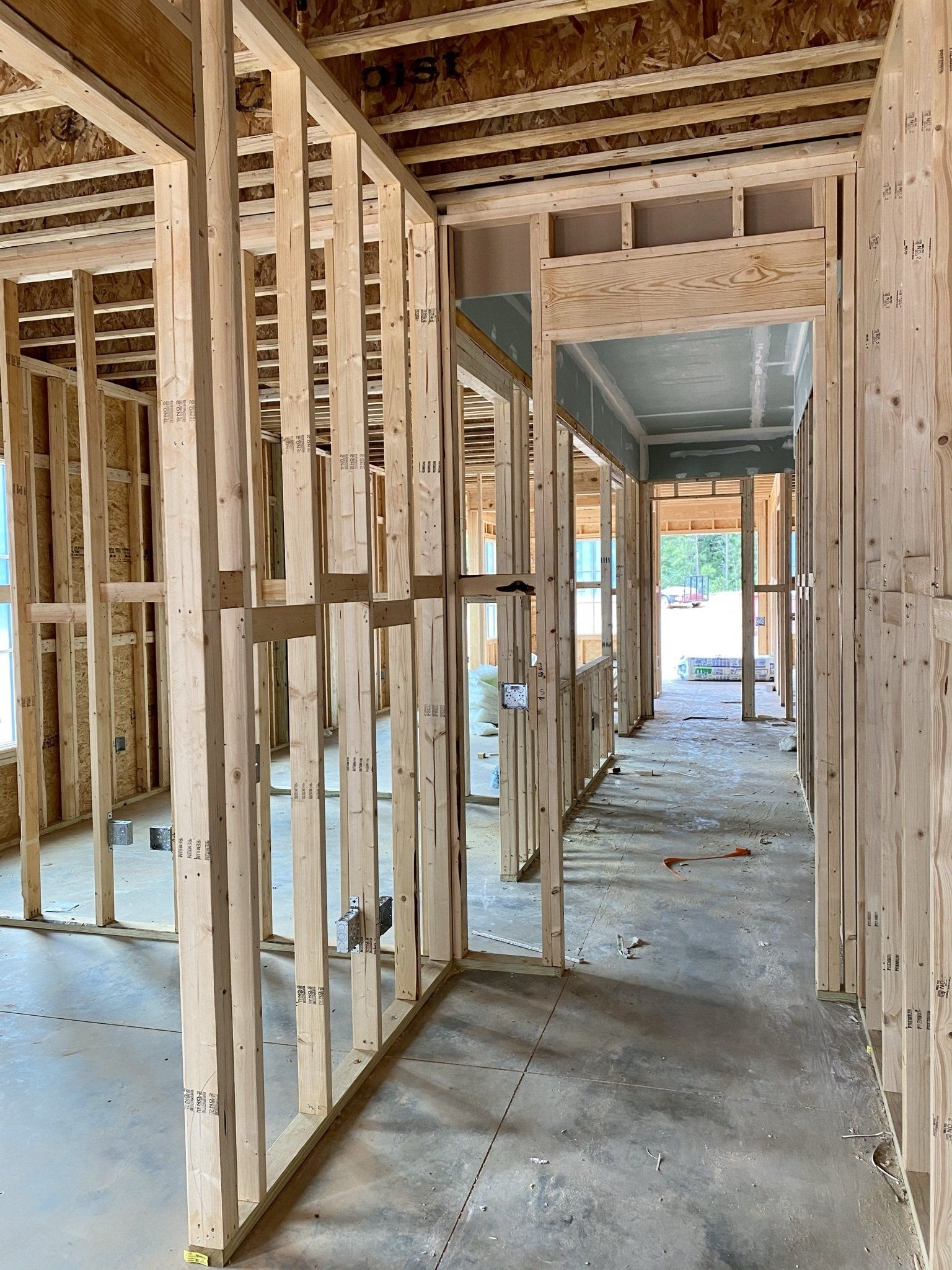 A hallway in a house under construction with wooden frames.