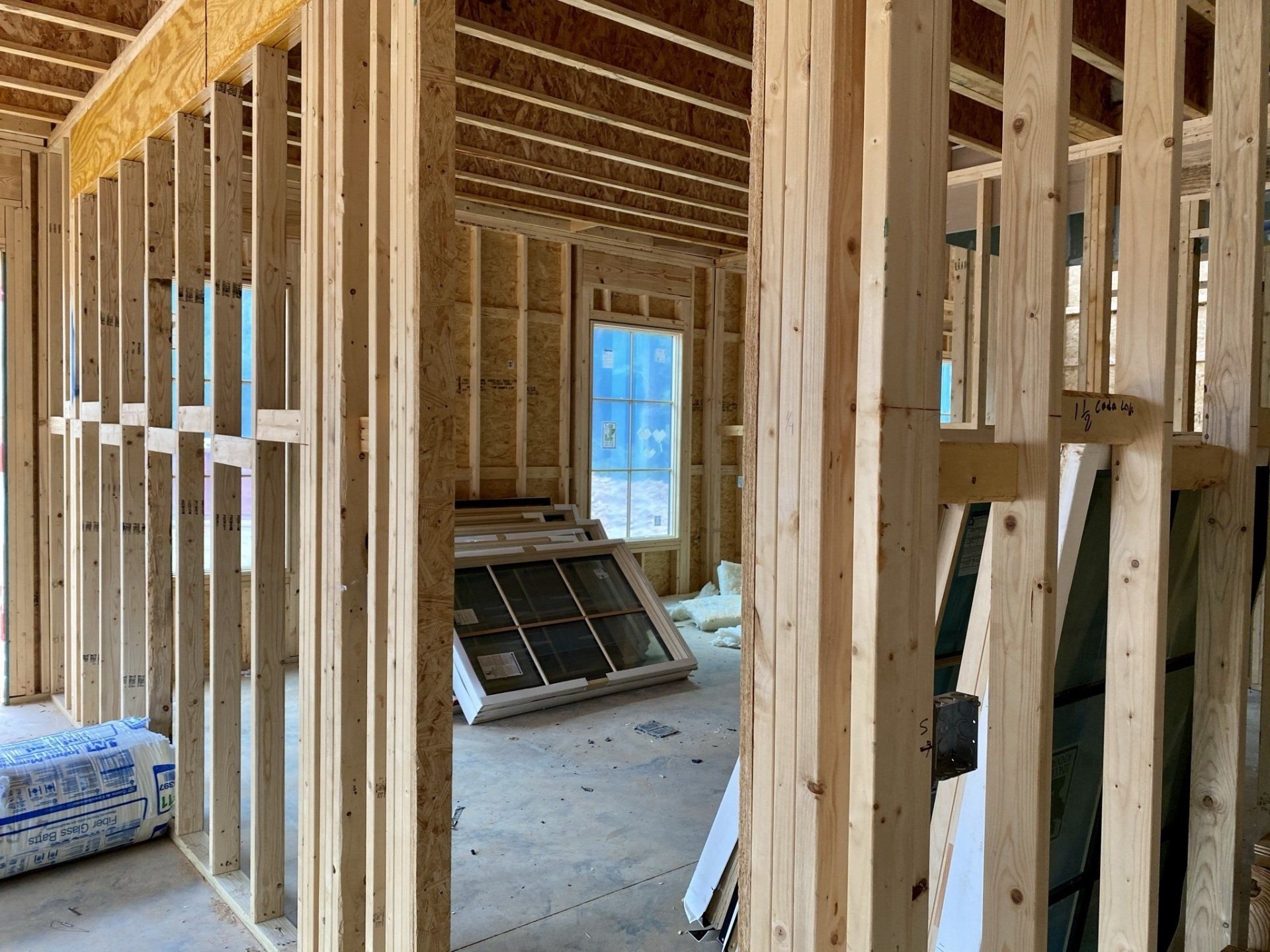 A house is being built with wooden beams and a window.