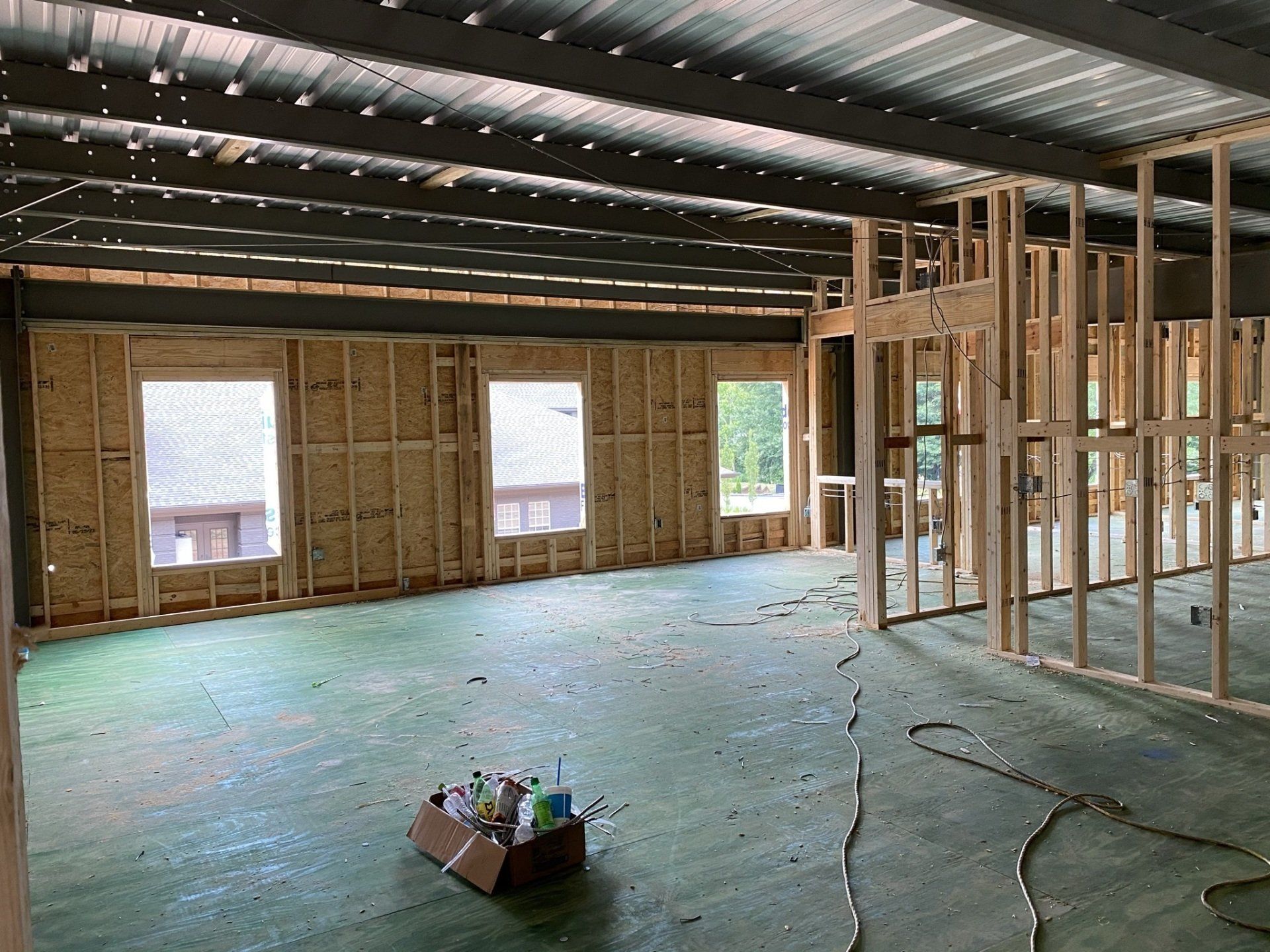The inside of a building under construction with a box on the floor.