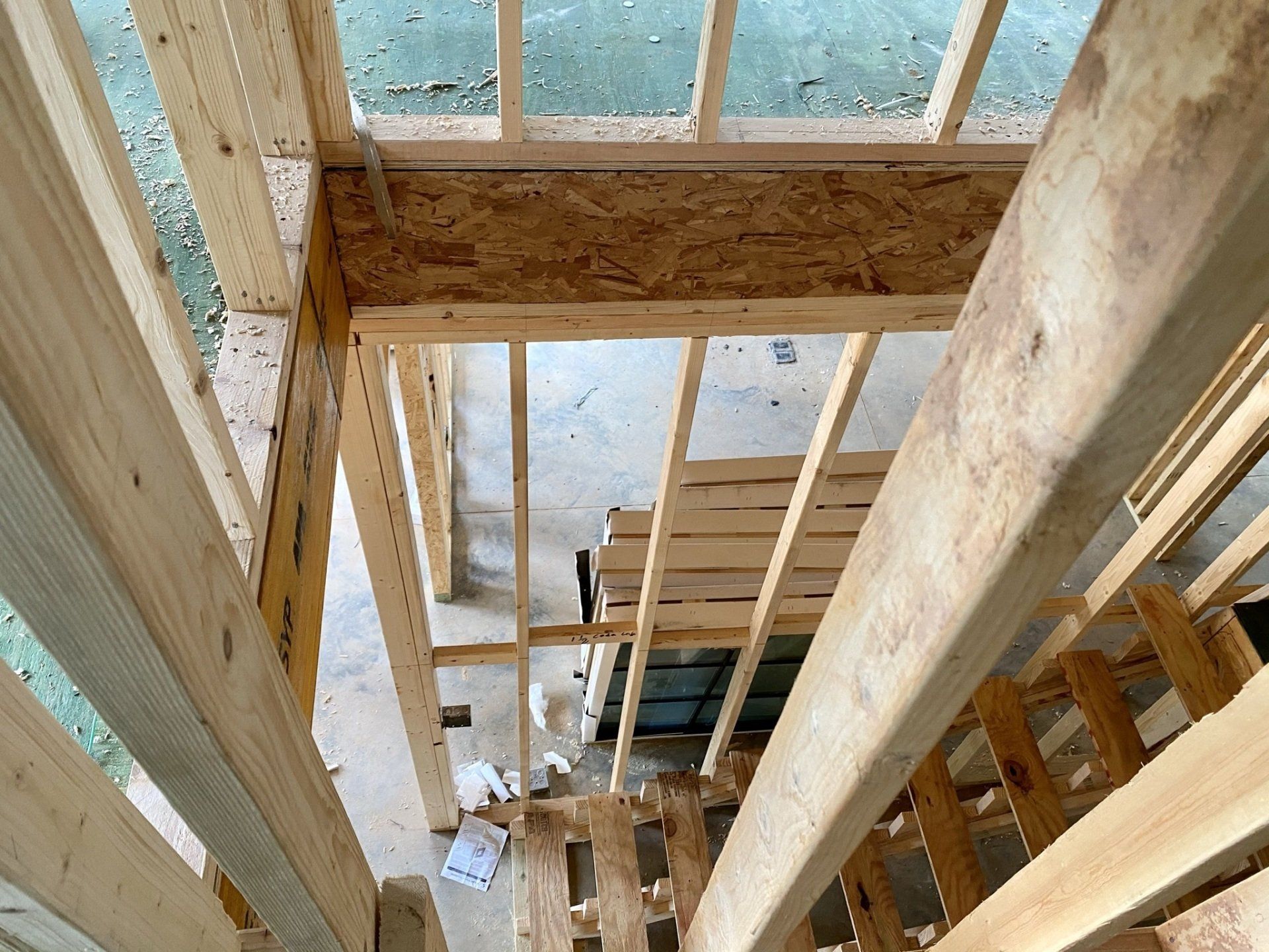 Looking up at a wooden structure under construction.