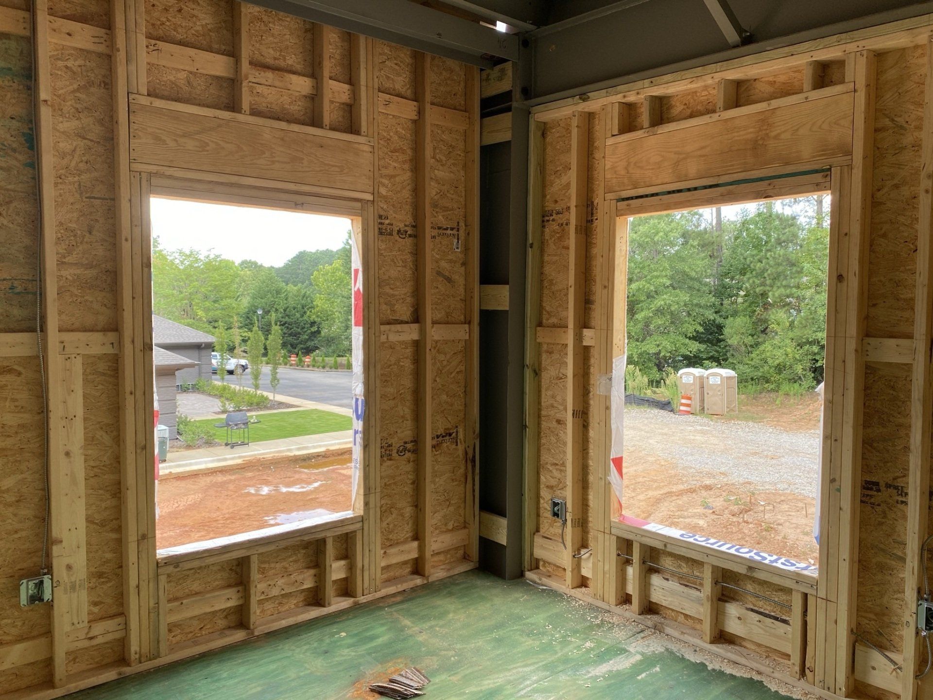 A room with a lot of windows in a house under construction.