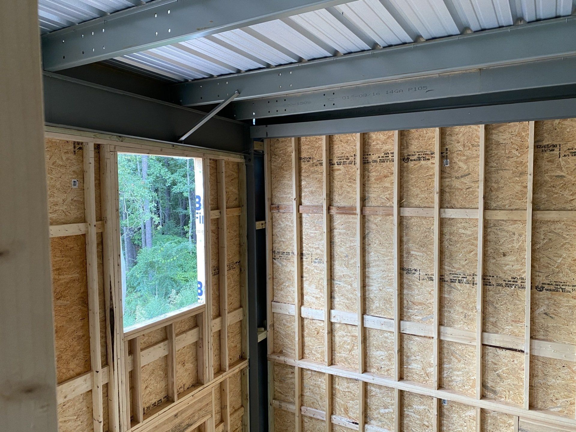 A room with wooden walls and a window in it.