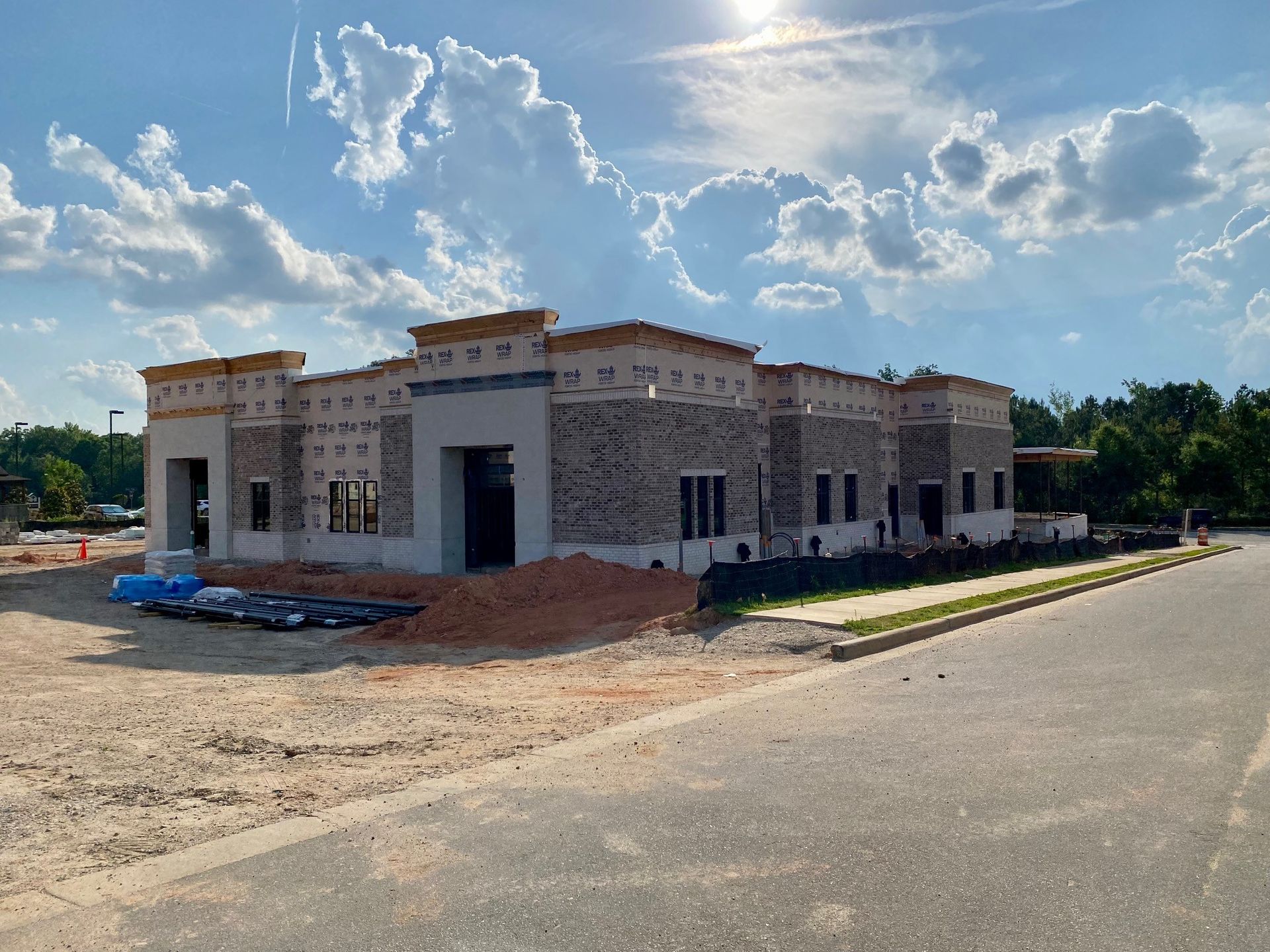 A large building is being built on the corner of a street.