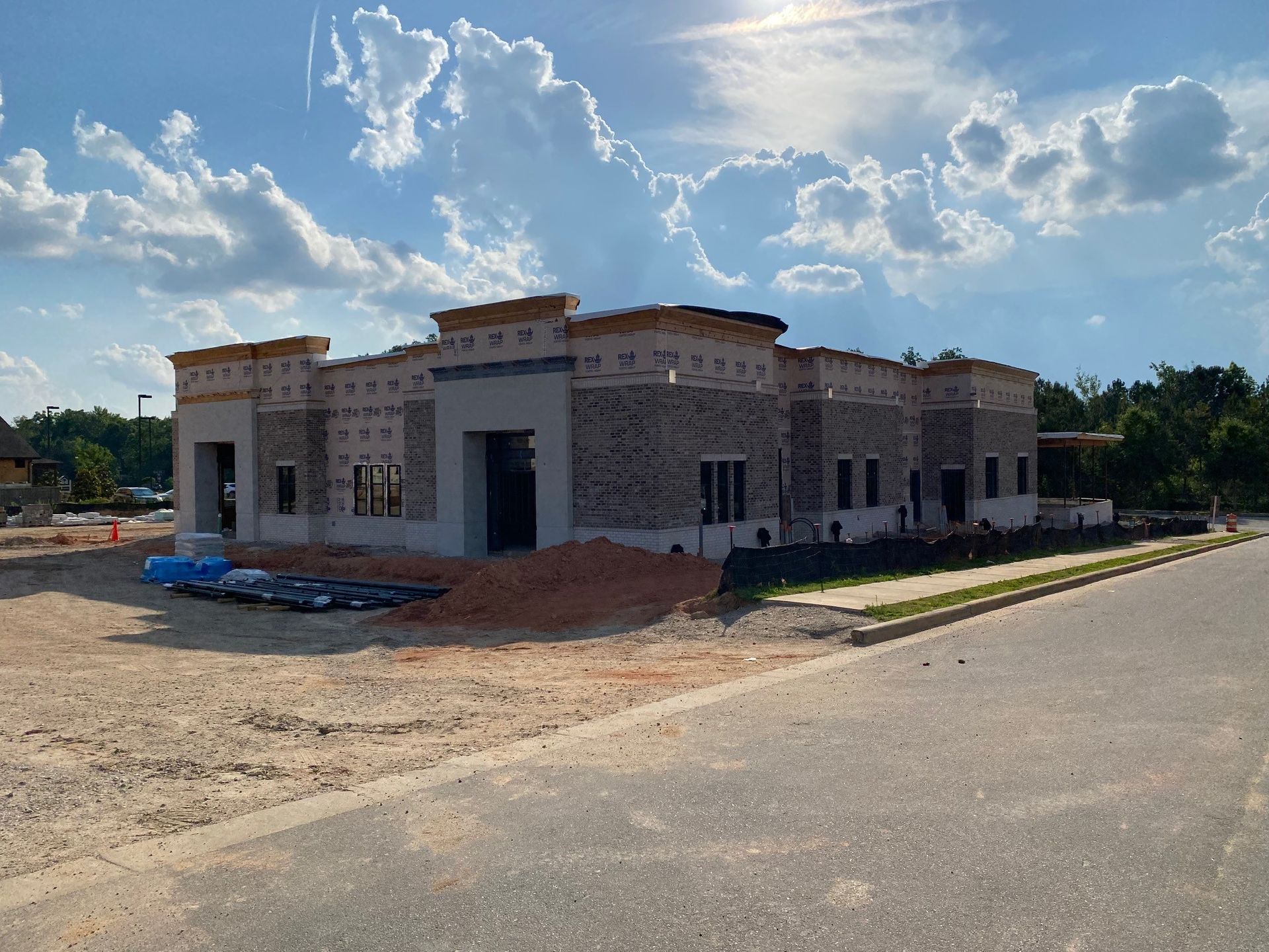 A large building is being built on the side of a road.