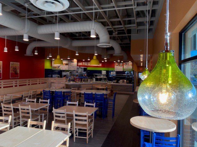 The inside of a restaurant with tables and chairs