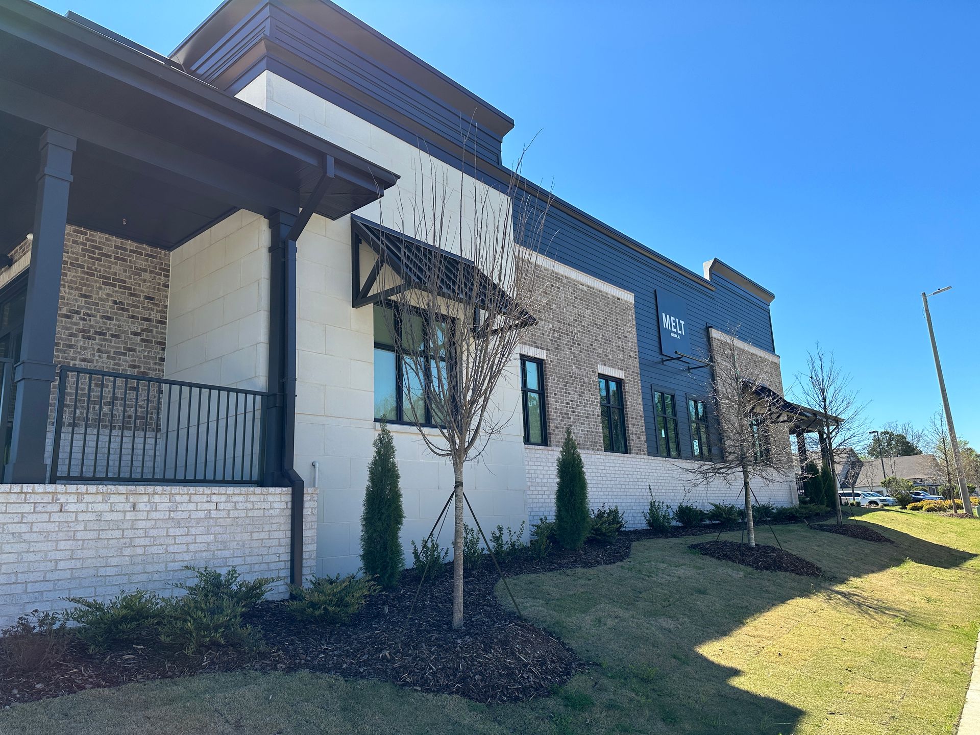 A large building with a lot of windows and trees in front of it.
