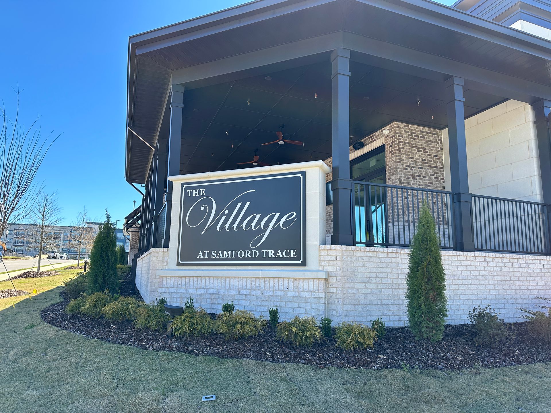 A sign for the village is on the side of a building.