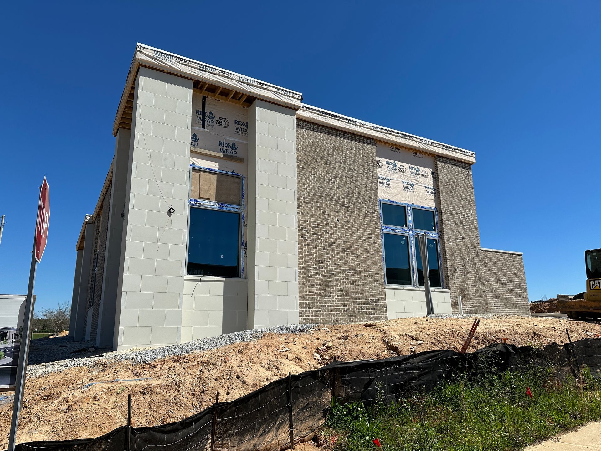 A building that is being built with a lot of windows.