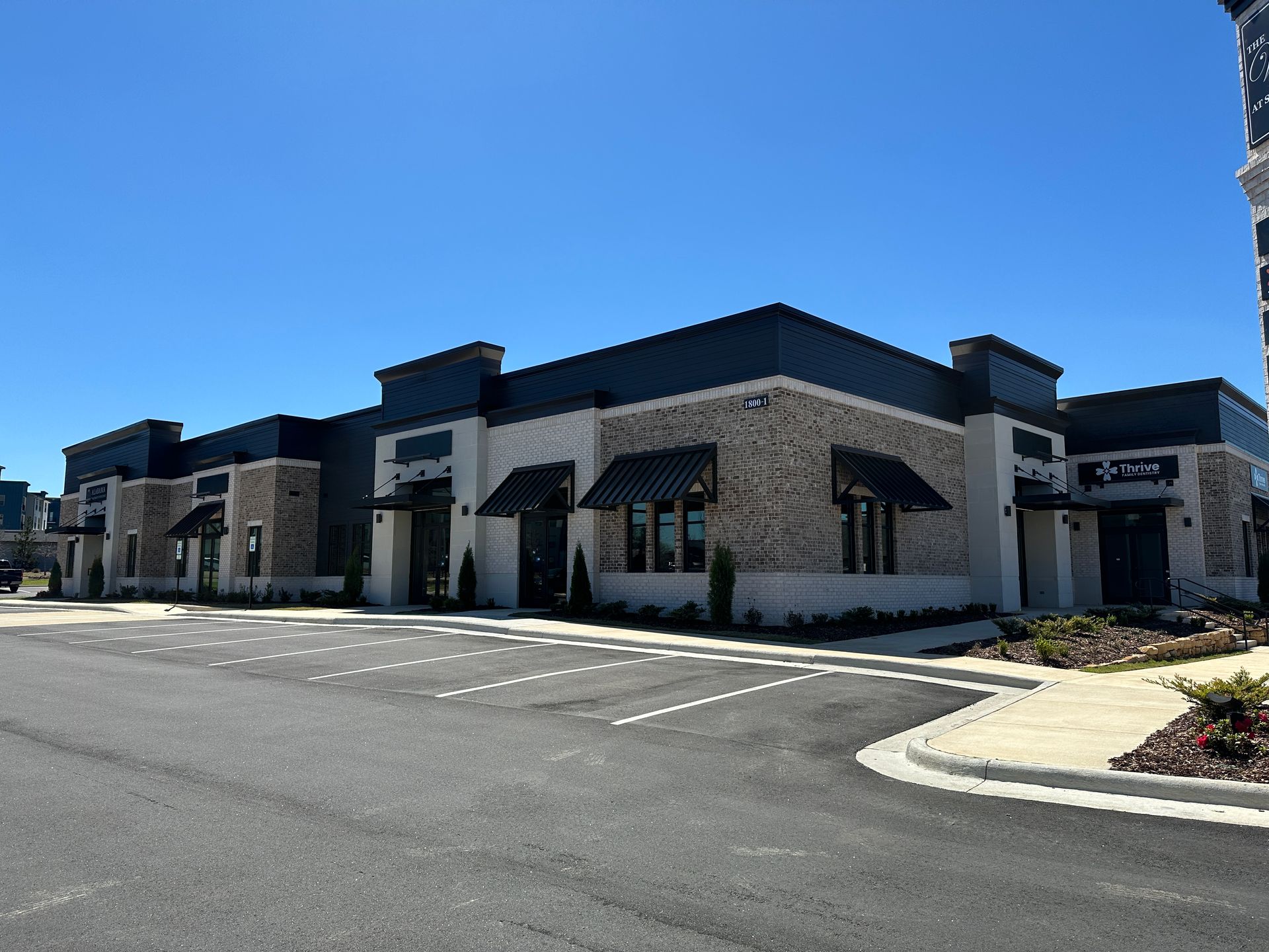 A large building with a lot of windows and awnings on the side of it.