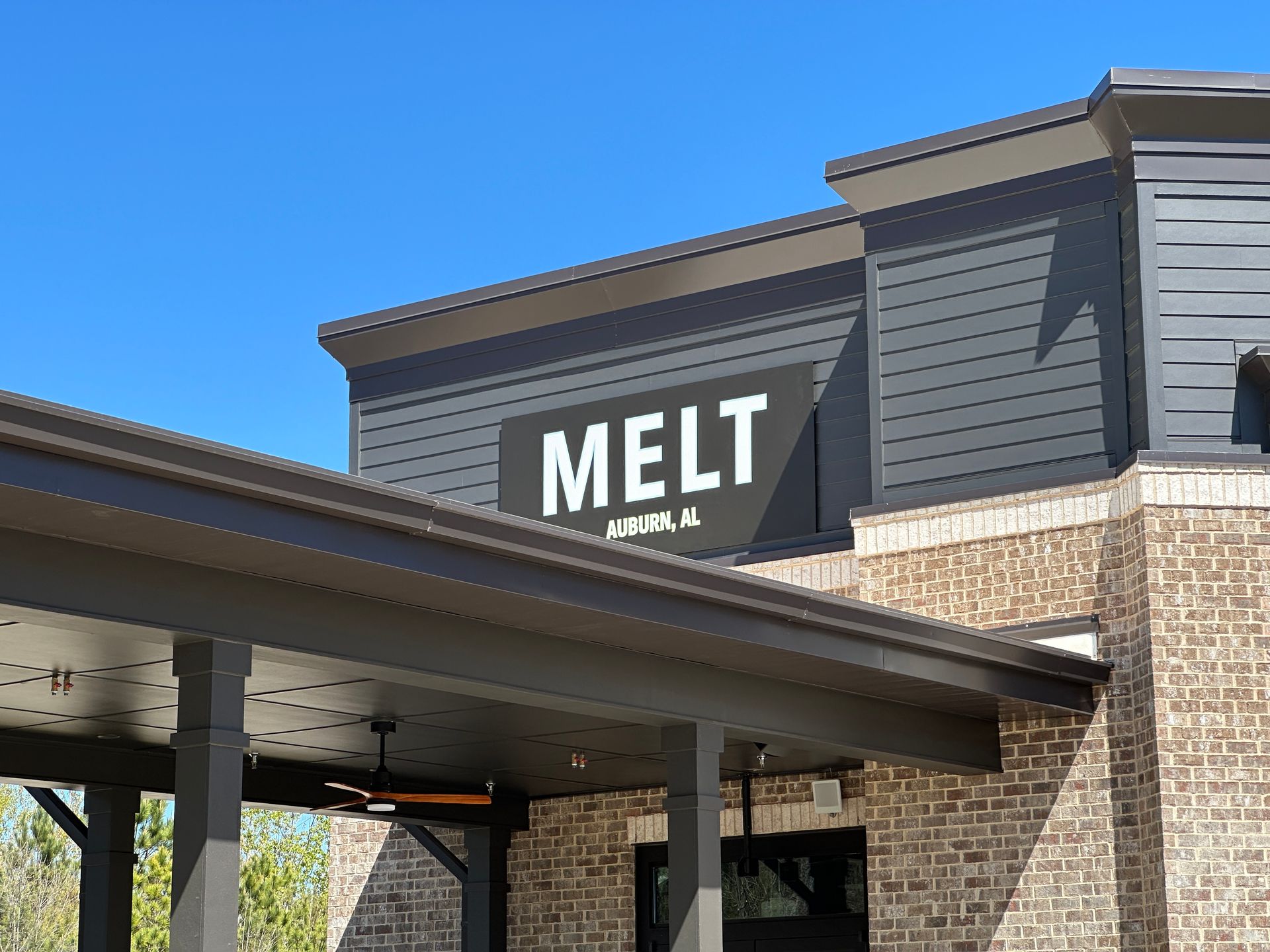 A brick building with a sign that says melt on it.