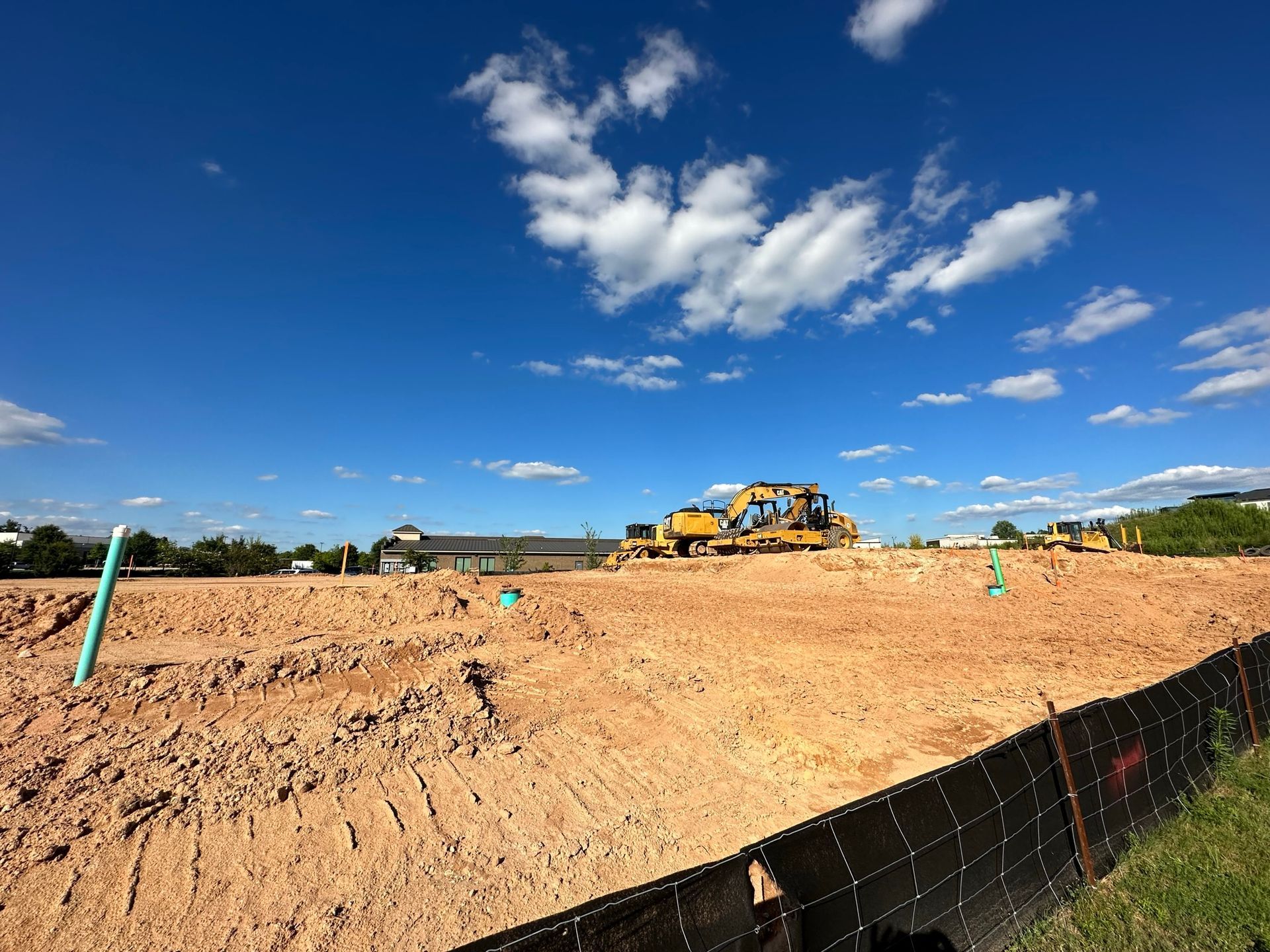A construction site with a bulldozer in the middle of it.