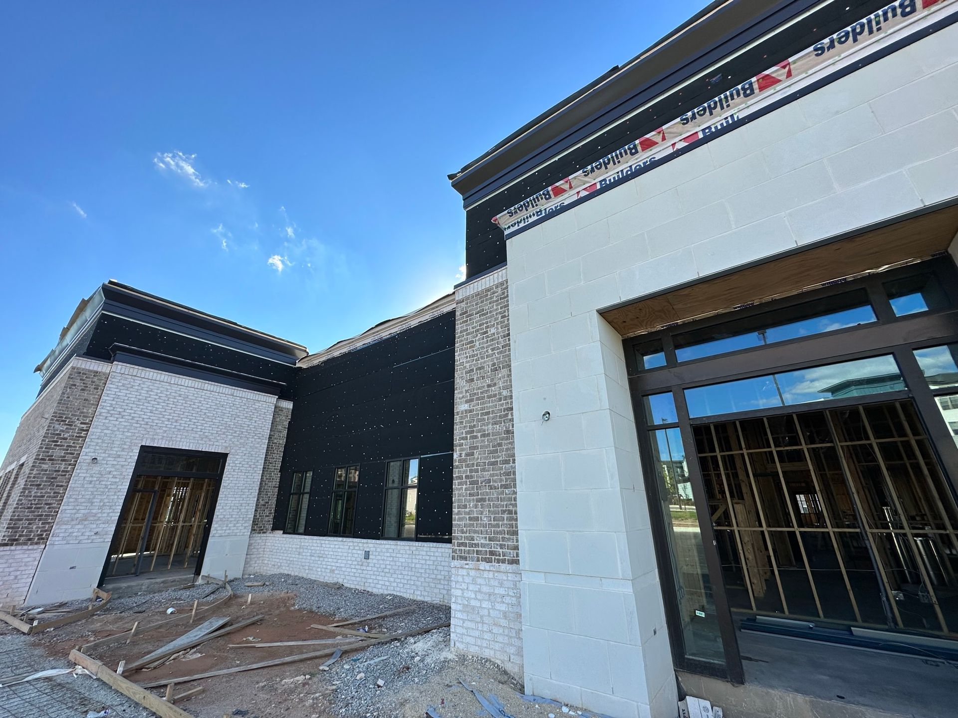 A building under construction with a blue sky in the background