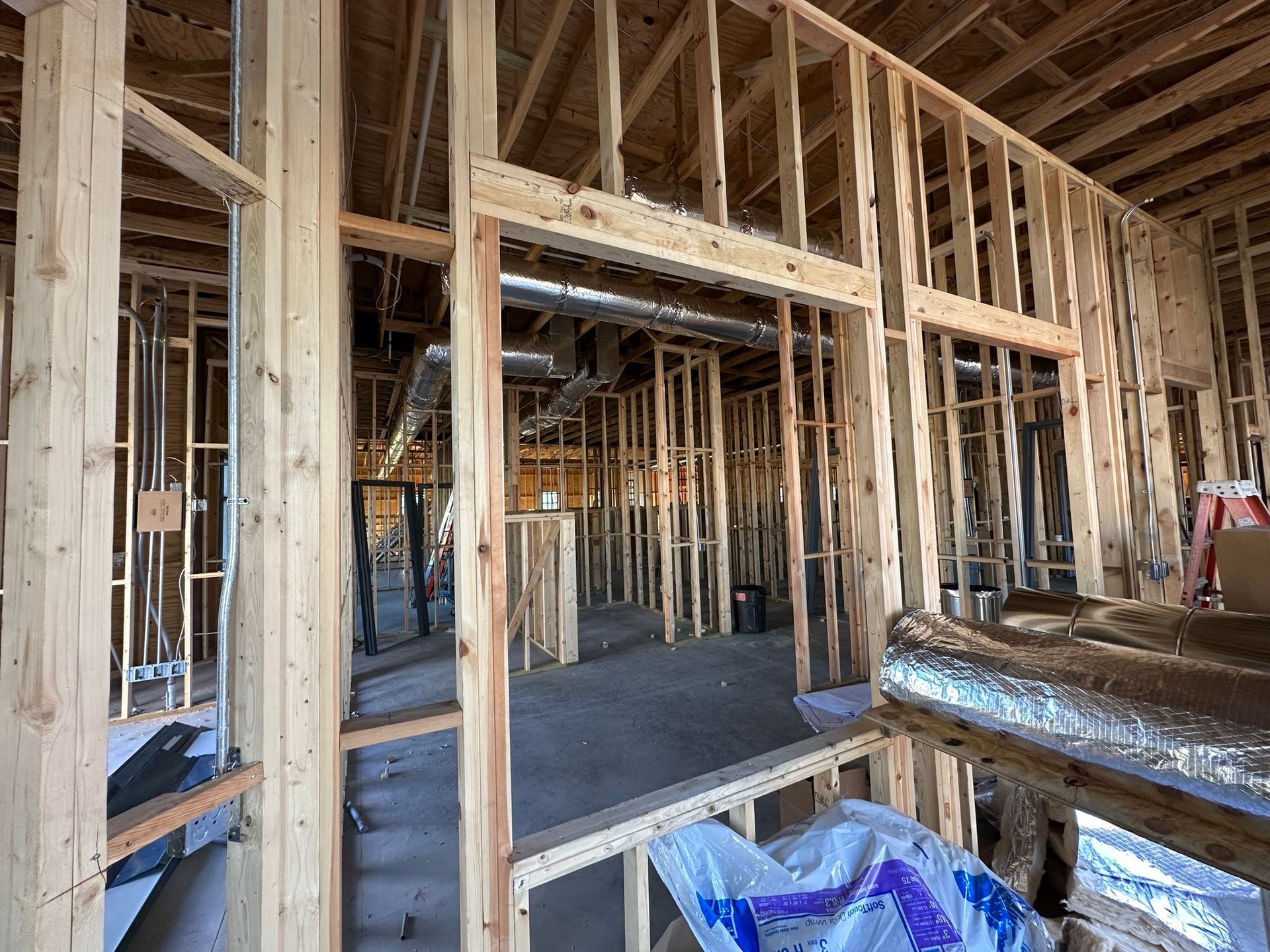 The inside of a building under construction with a lot of wooden beams.