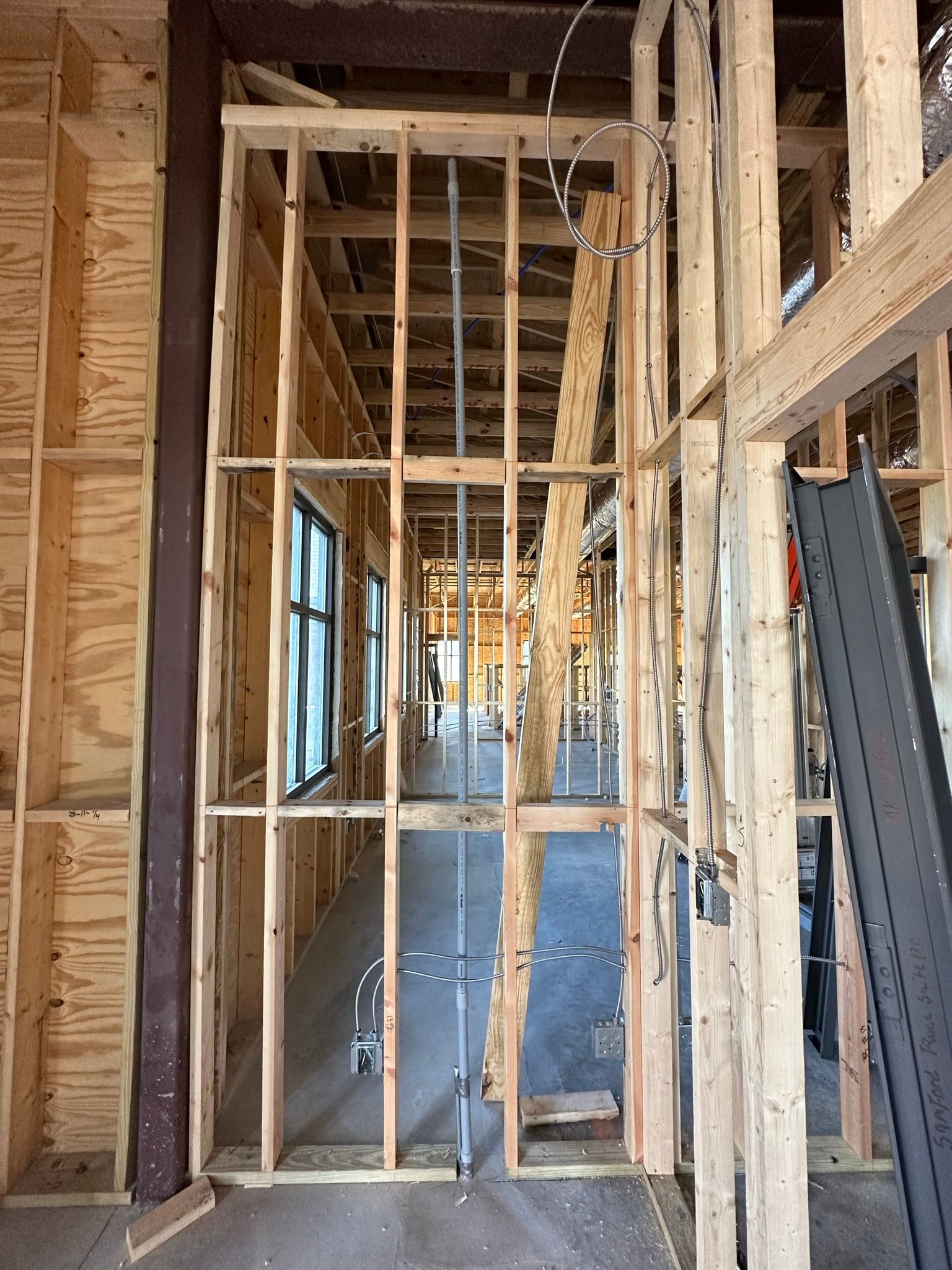 The inside of a building under construction with wooden beams.