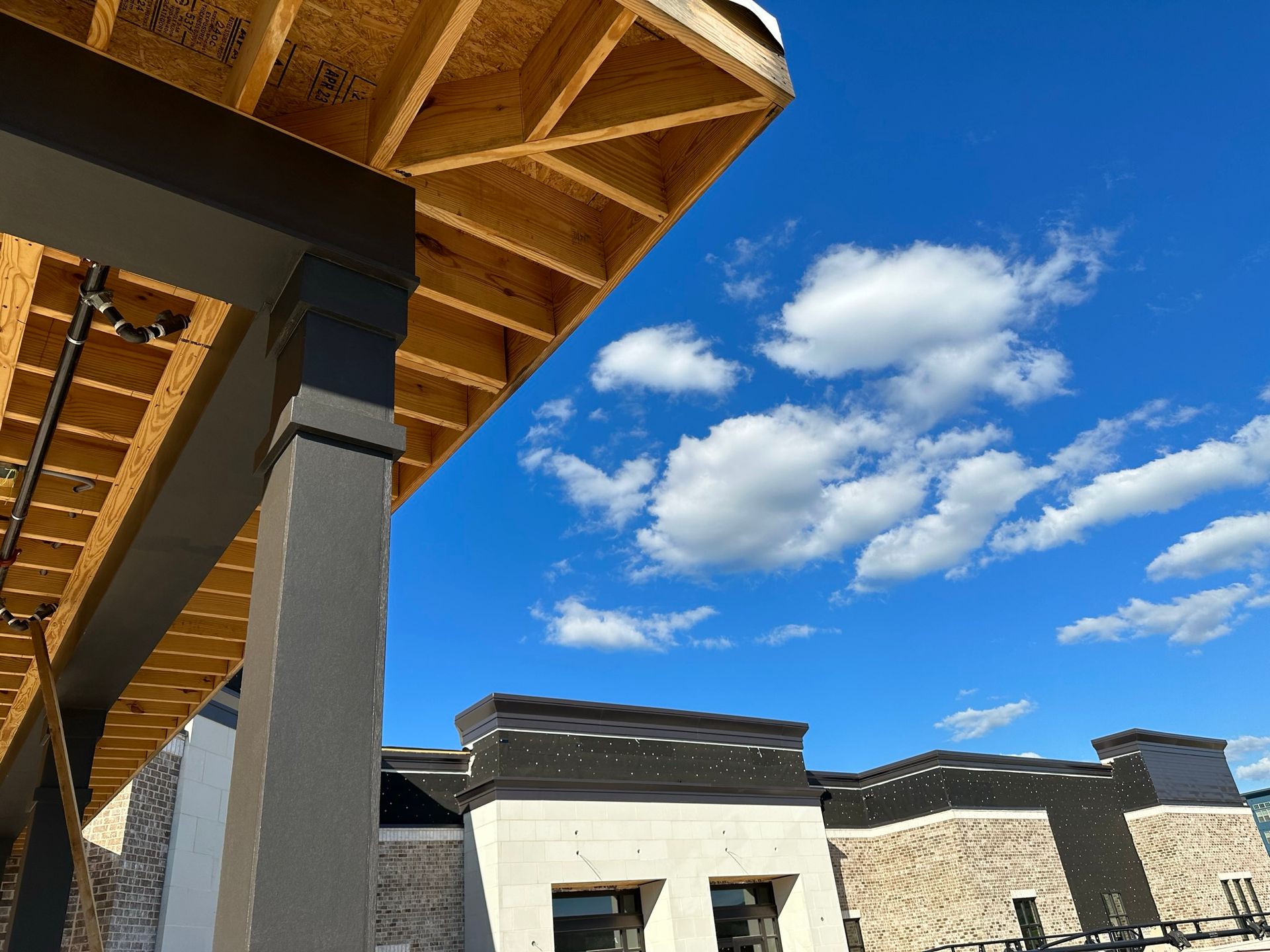 A building under construction with a blue sky in the background.