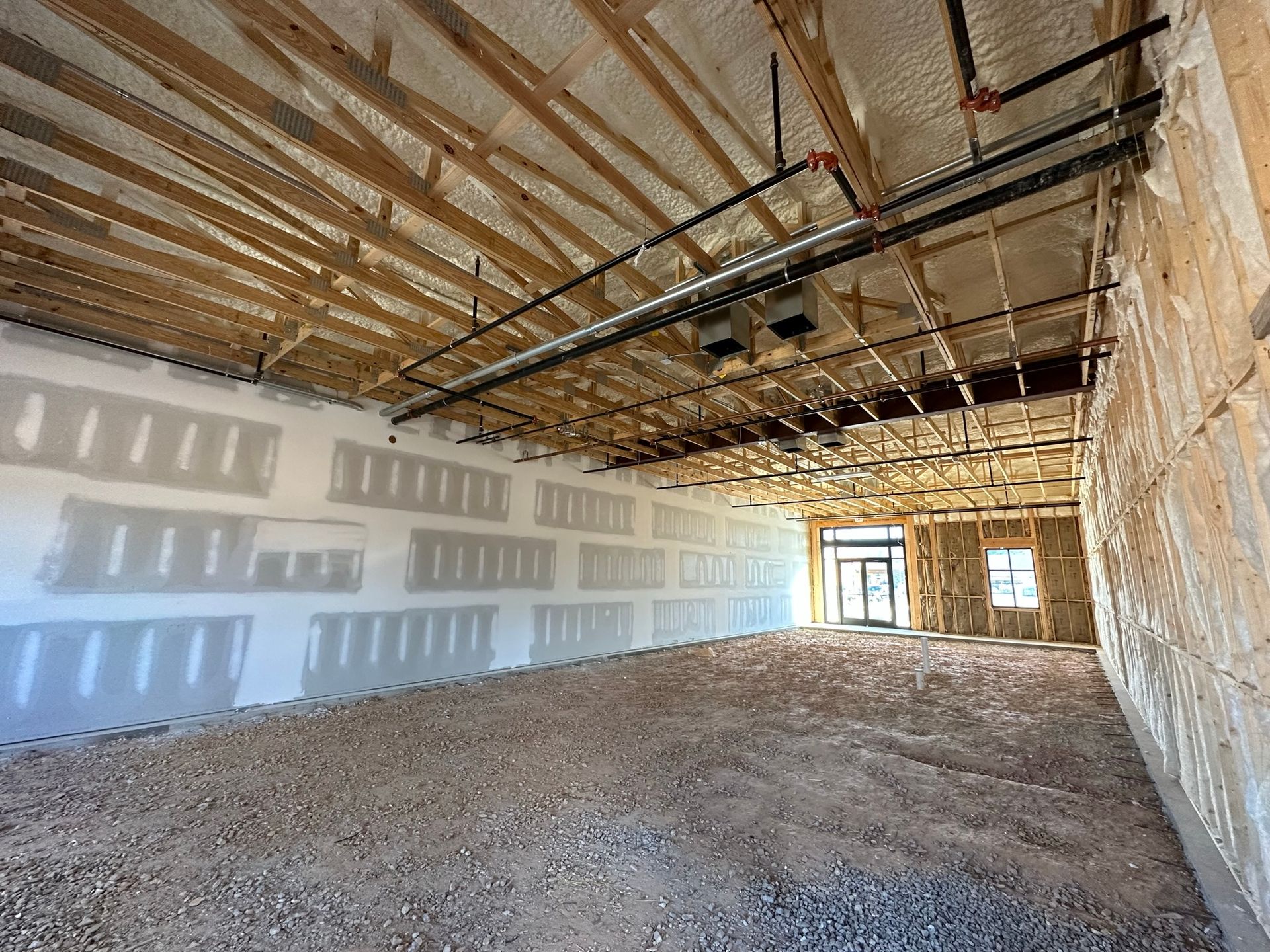 A large empty room with a ceiling that is being built.