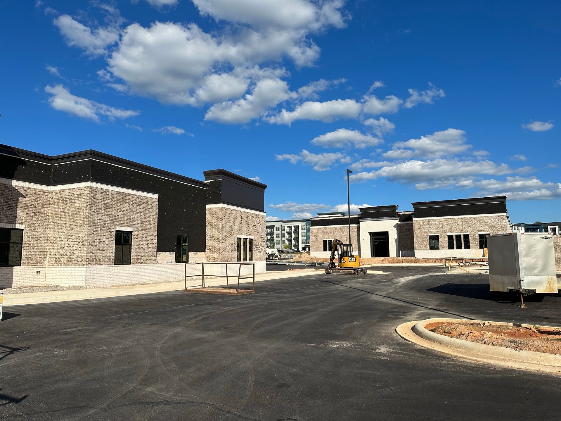 A group of buildings are being built on a sunny day.