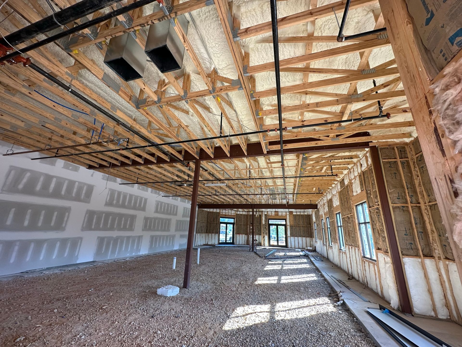 The inside of a building under construction with a lot of wooden beams.