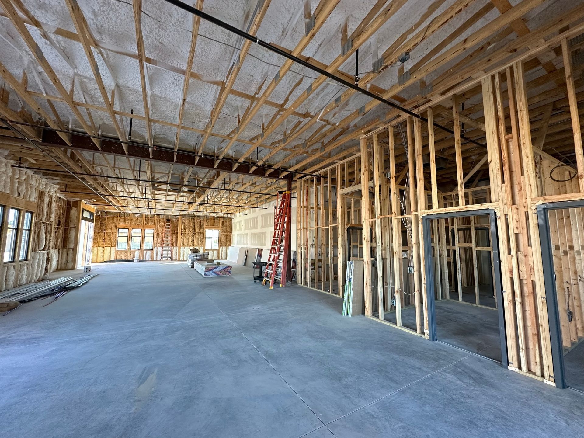 A large room under construction with a lot of wooden beams.