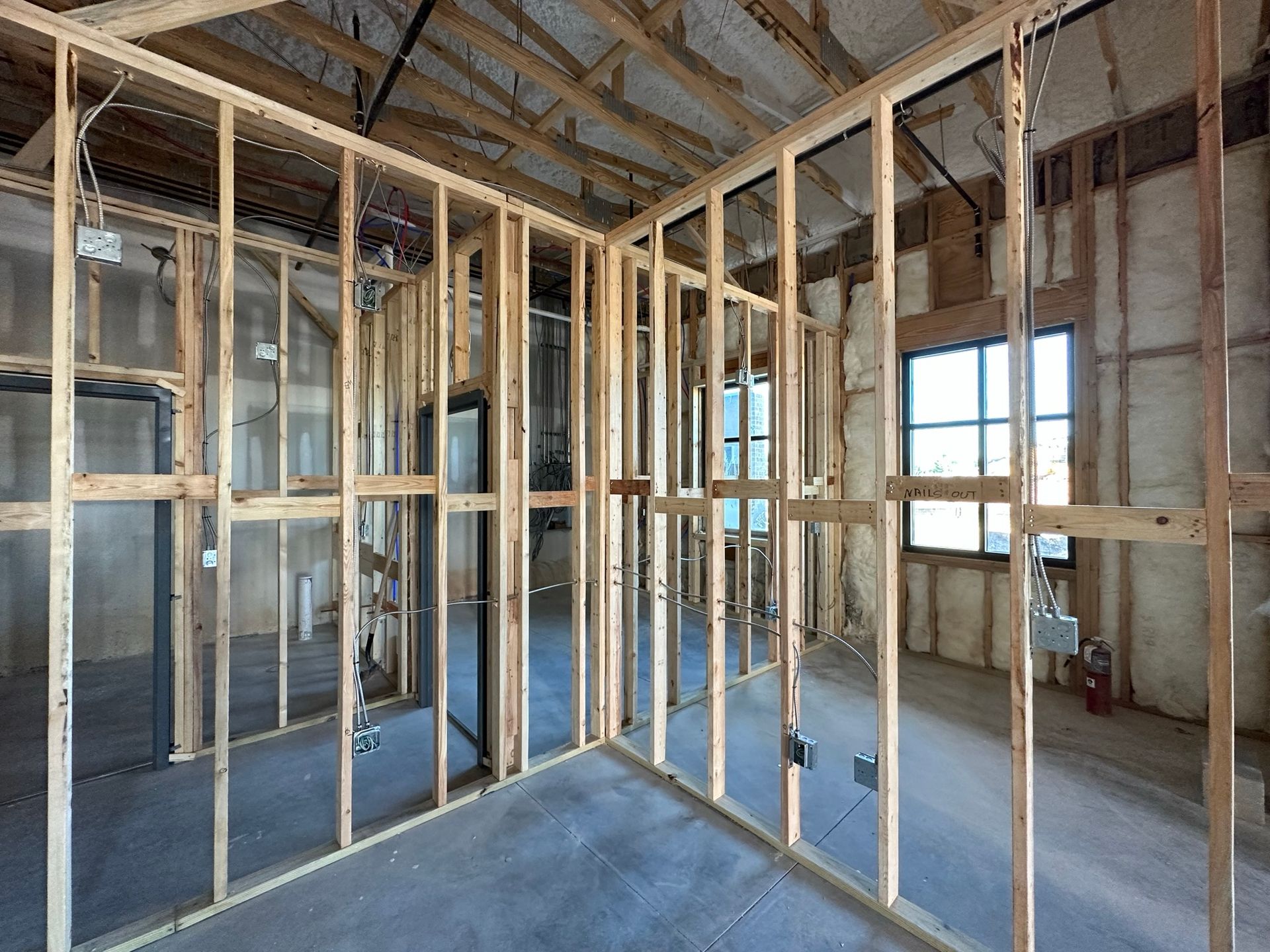 An empty room with a lot of wooden walls and windows