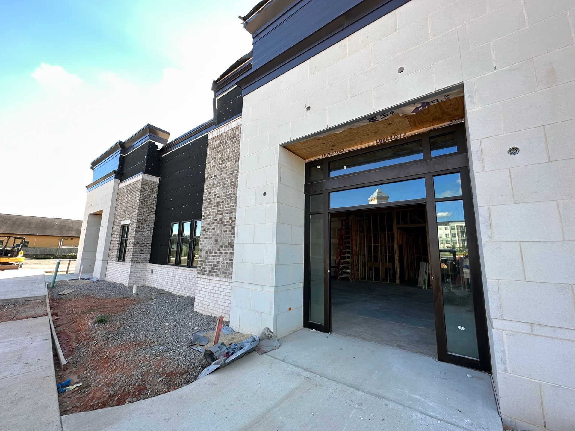 A building under construction with a large garage door.