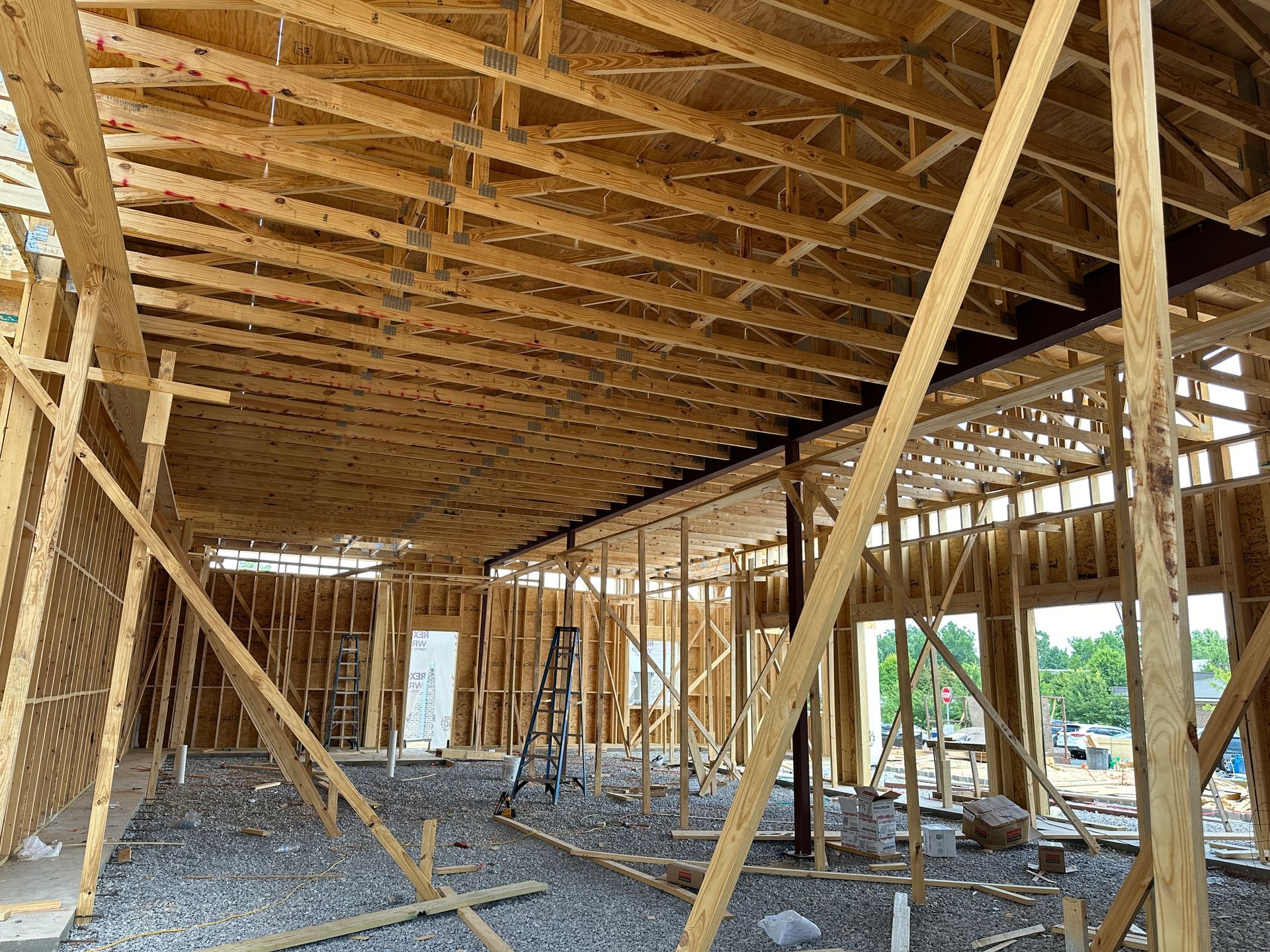 The inside of a building under construction with wooden beams.
